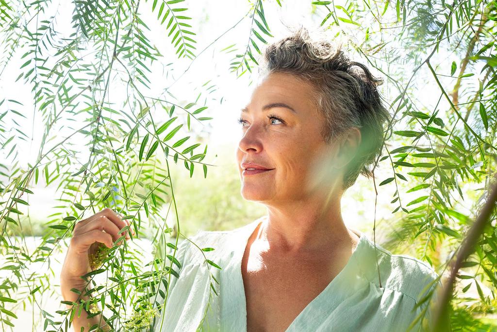 A woman in the forest in the summer sun