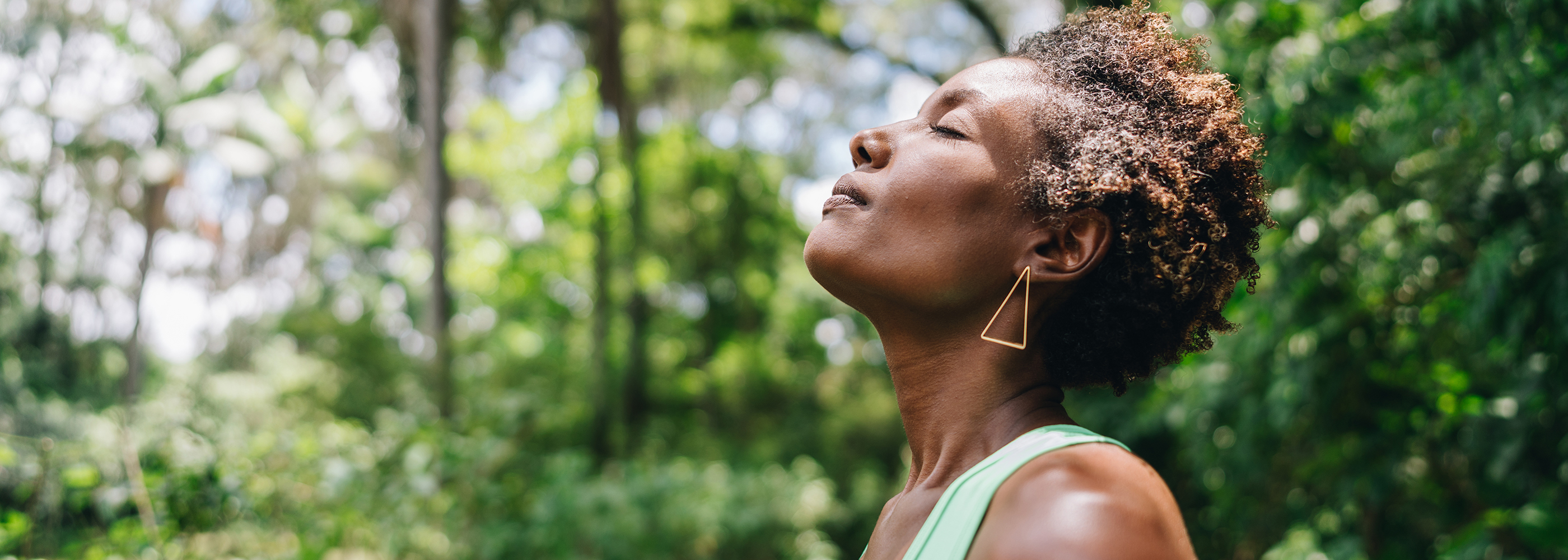 A woman meditating in the forest
