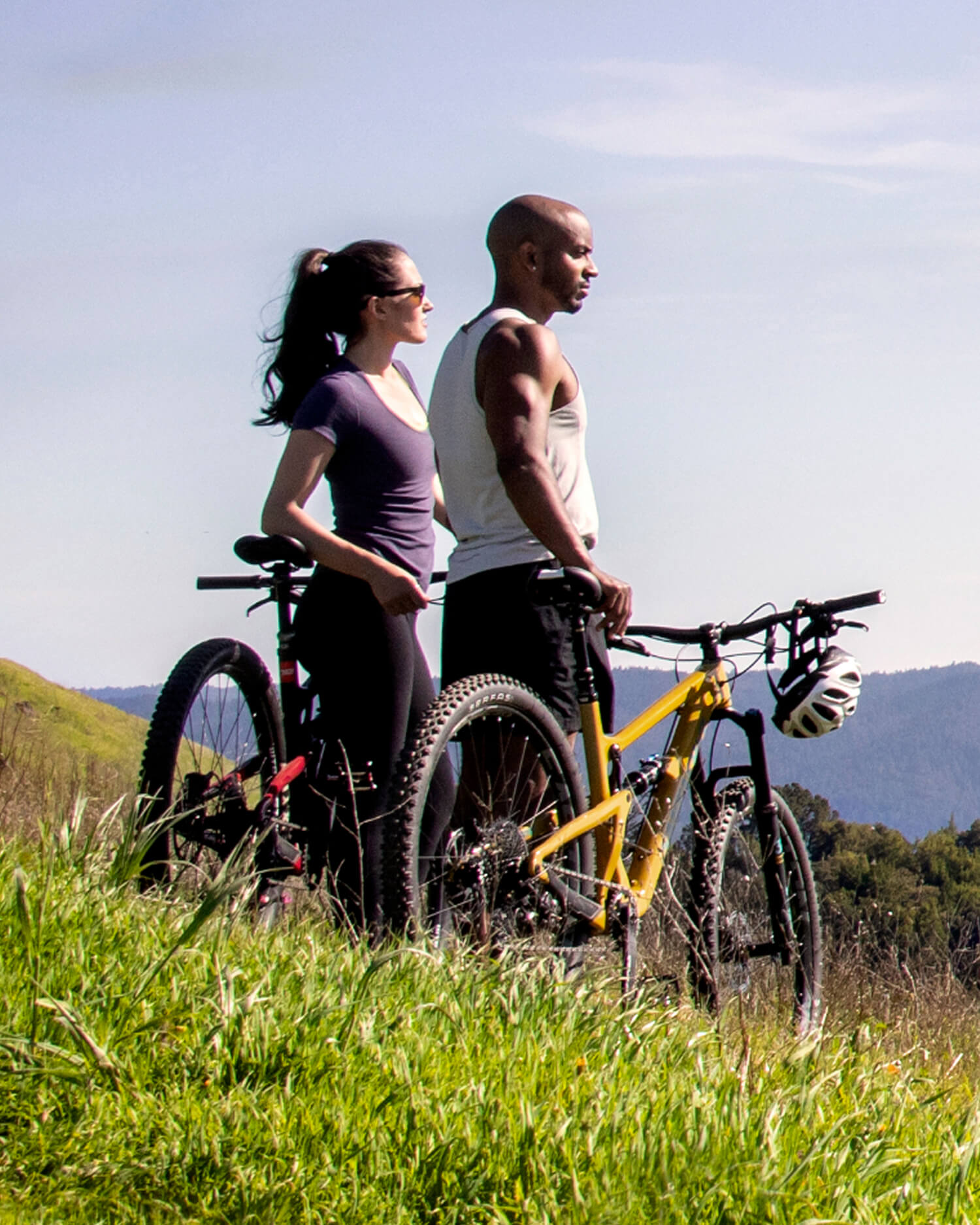 A couple on mountain bikes on a hill