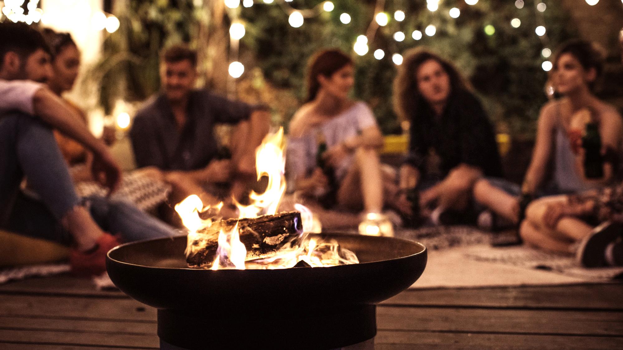 People outside at Woodside around the fire