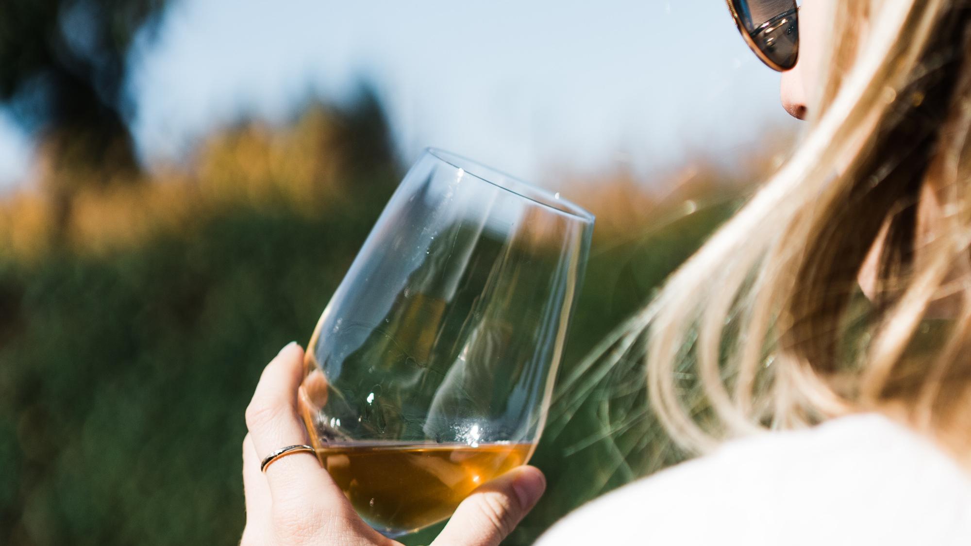 Person holding a glass of wine