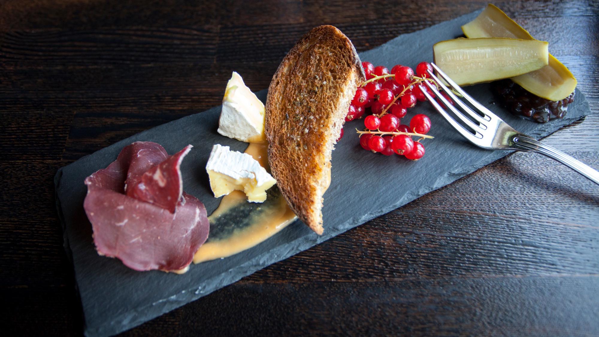 A charcuterie plate with meat and cheese