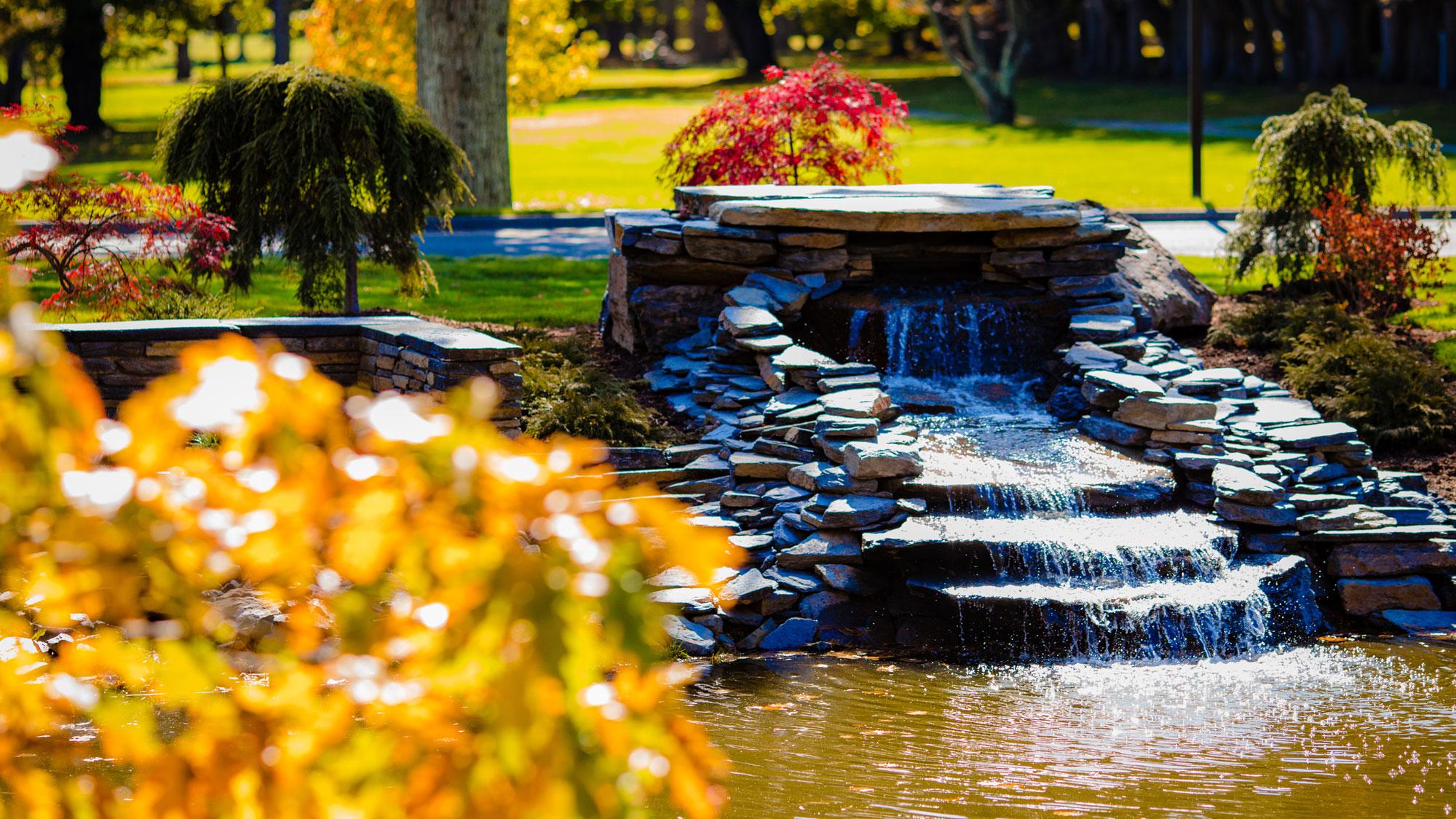 Picture of on-property waterfall amid beautiful fall foliage