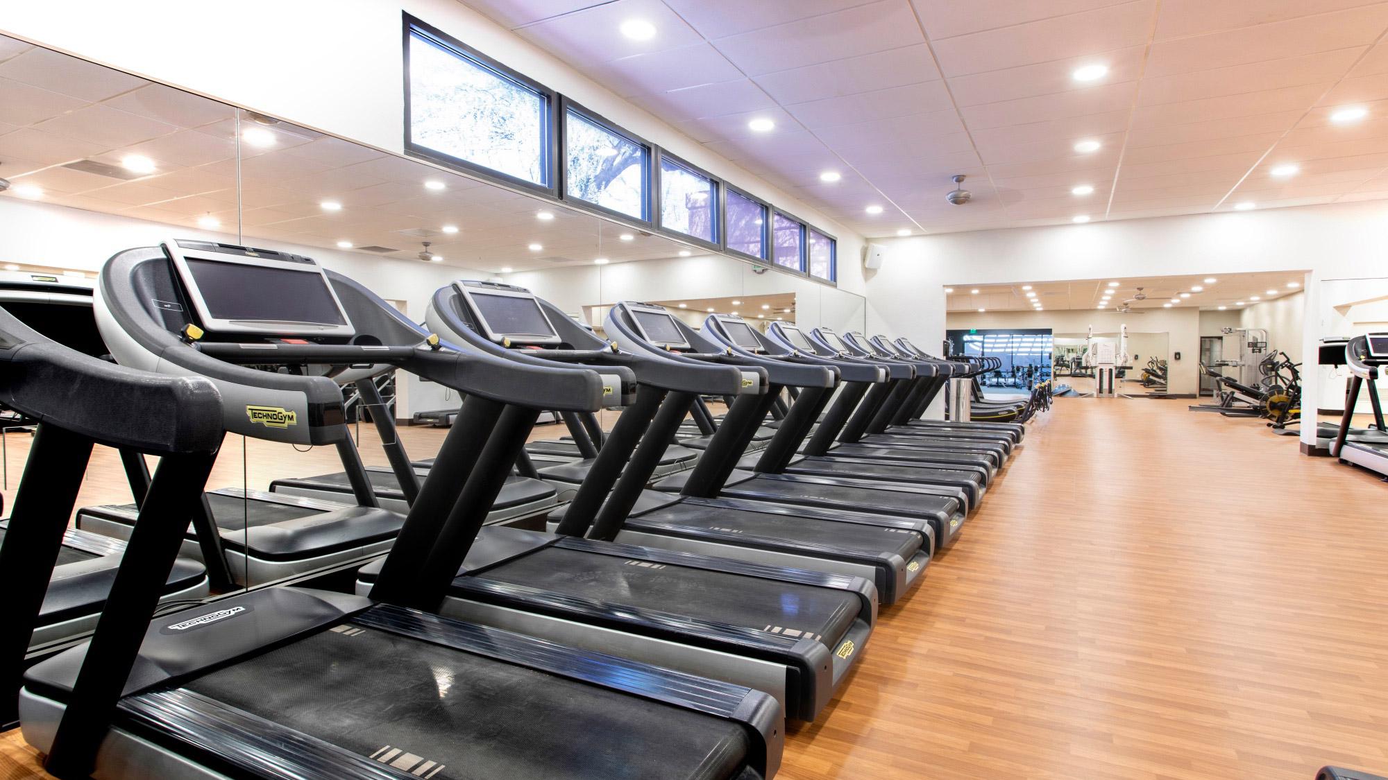 Row of multiple treadmills in the fitness gym