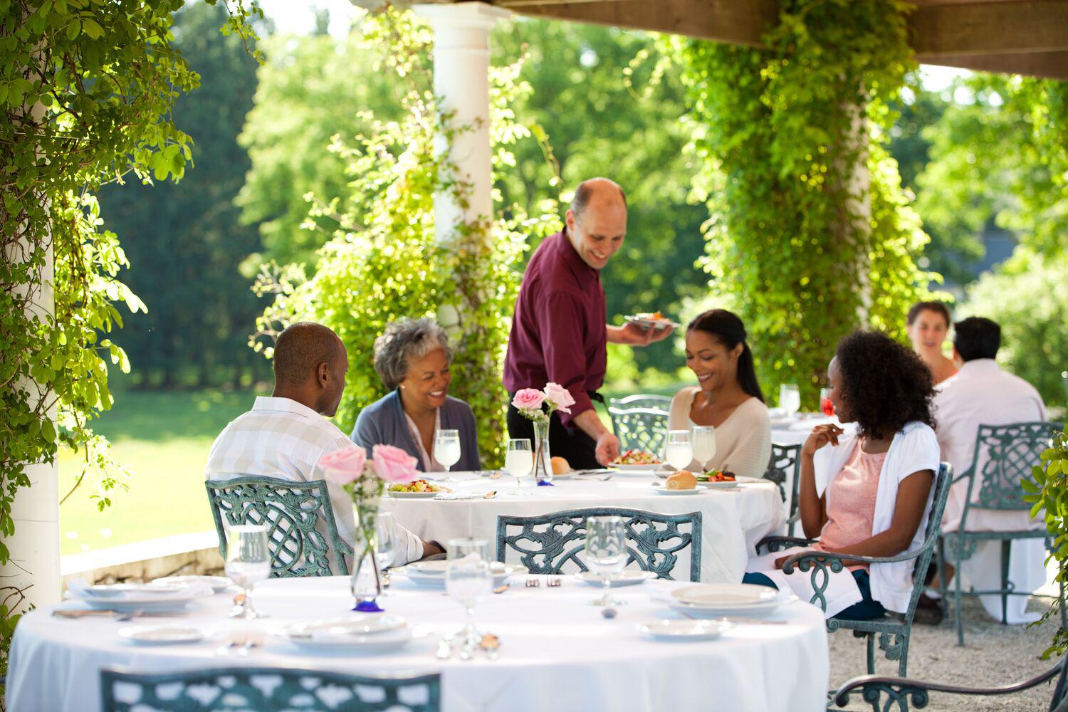 Family eating out on the patio at Canyon Ranch Lenox Spa Resort