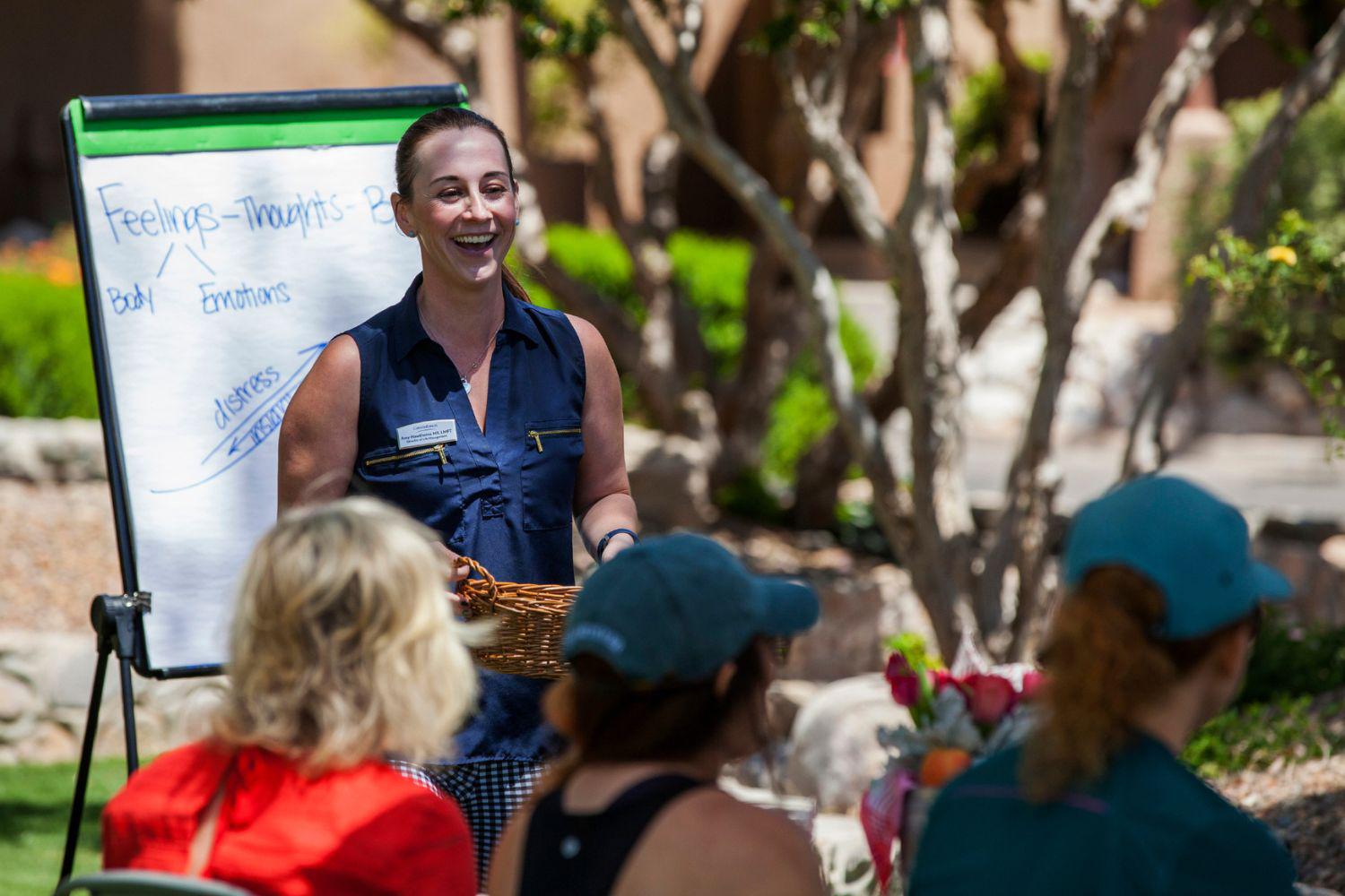 Corporate executives at a group retreat giving an outdoor presentation at Canyon Ranch Spa + Fitness Resort in Lenox