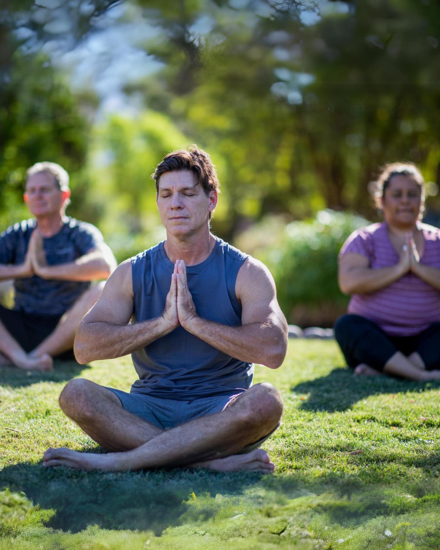 A group doing yoga at peace park at Canyon Ranch Tucson in the Sonoran Desert