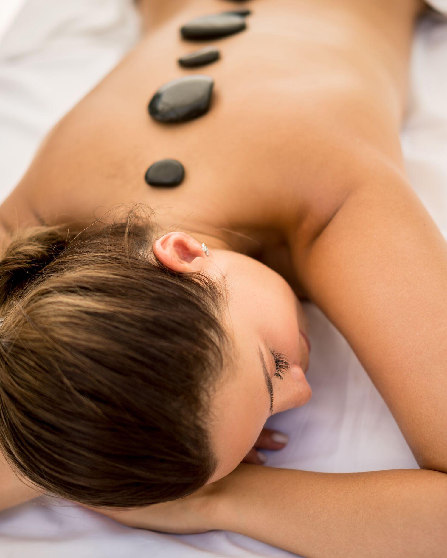 A woman getting a stone massage at Canyon Ranch Fort Worth Spa