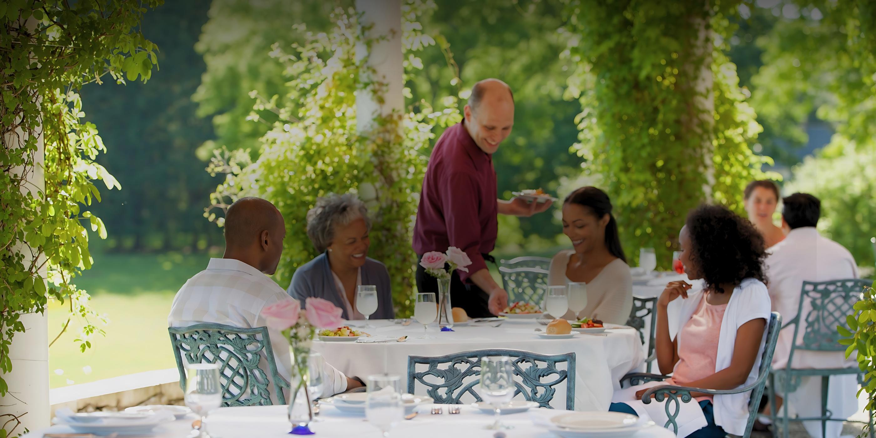 A family eating out on the patio at Canyon Ranch Lenox Spa Resort