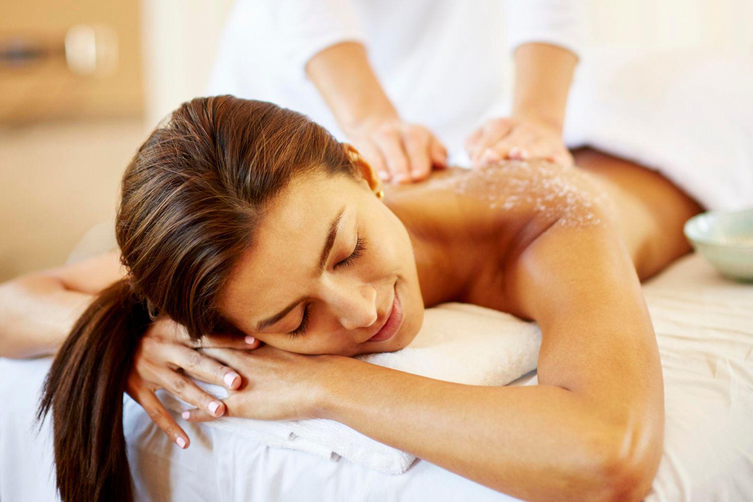 a woman enjoying a body scrub and massage treatment at the Canyon Ranch Lenox Spa + Beauty Salon