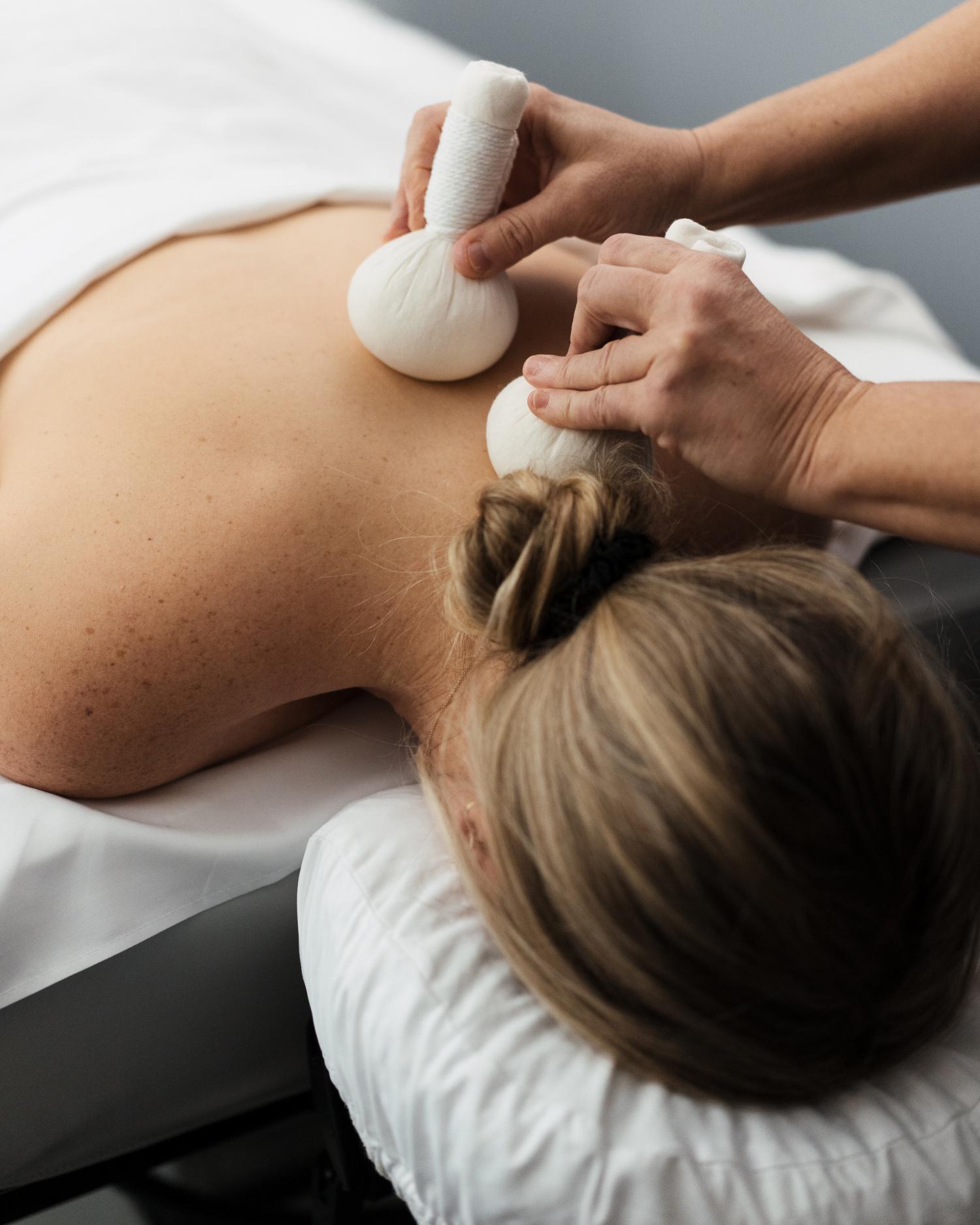 a woman getting a poultice massage at Canyon Ranch spa
