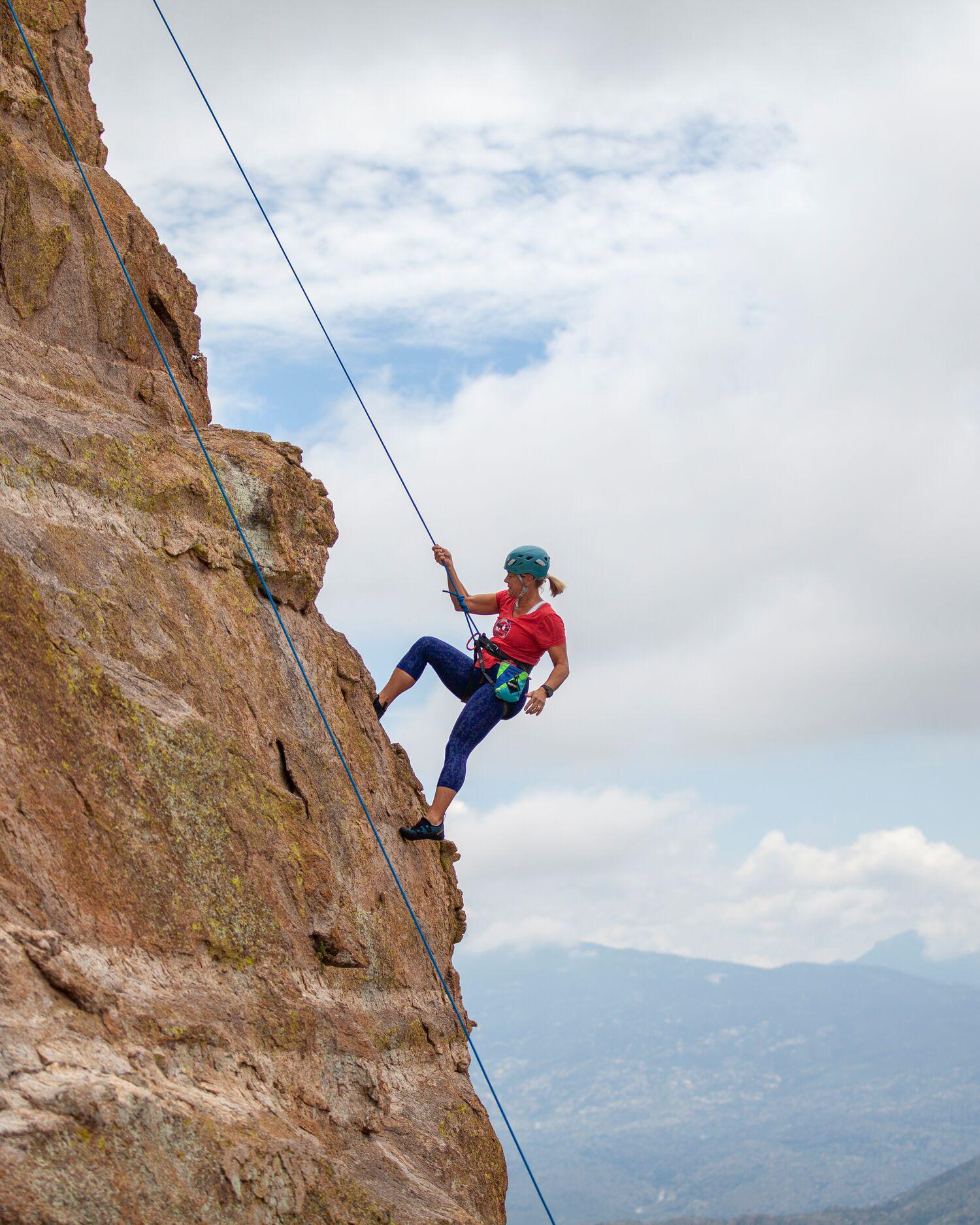 A woman Rock climbing in the desert