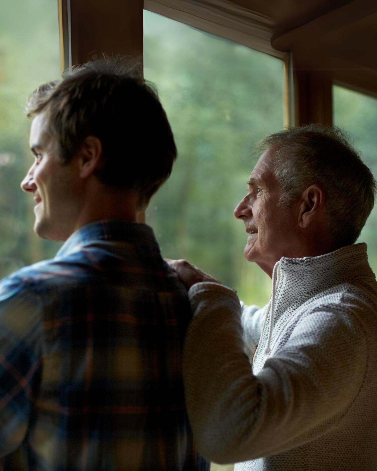 two men looking our the window at a father son retreat at Canyon Ranch Lenox Spa Resort