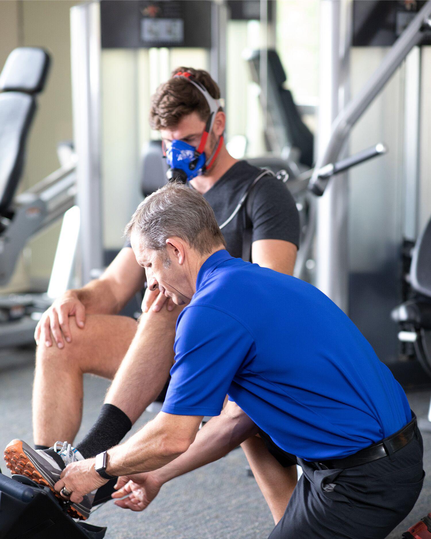 Performance Scientist meeting with a man doing a dynamic assessment. 