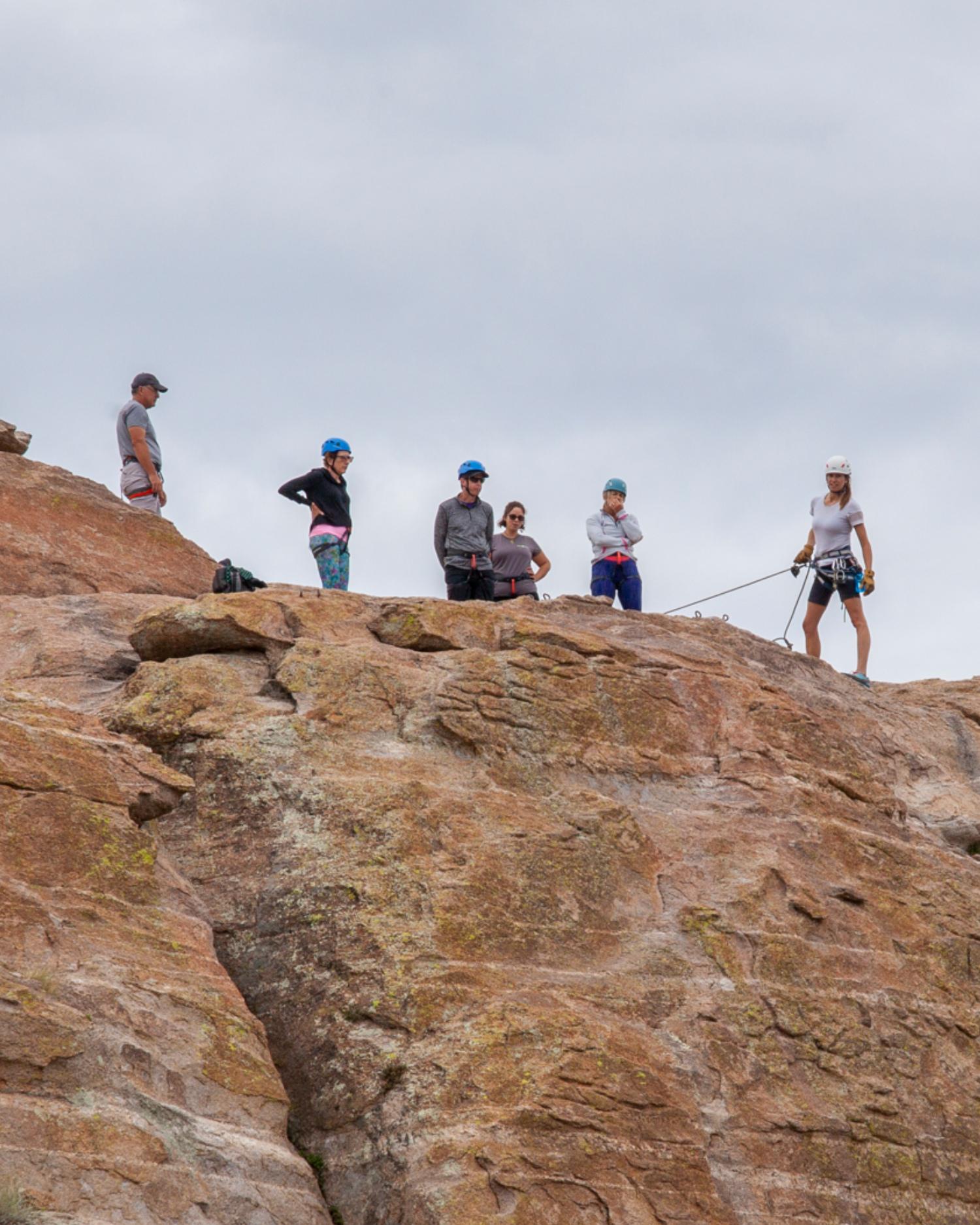 People participating in a outdoor teambuilding mountain climbing course at Canyon Ranch Tucson Wellness Resort
