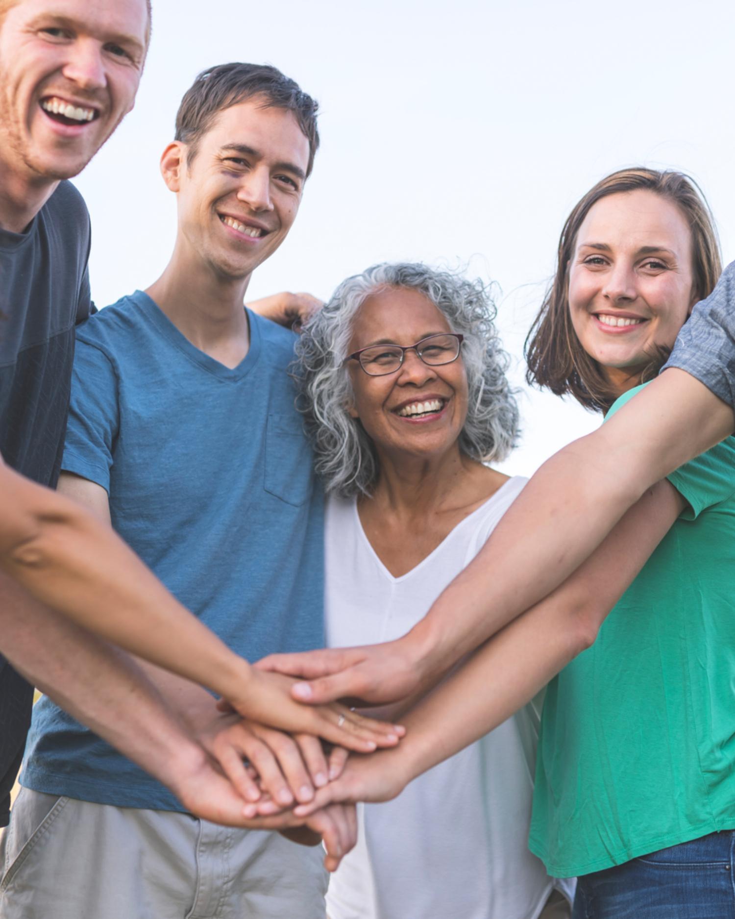 A family with hands in at a family reunion