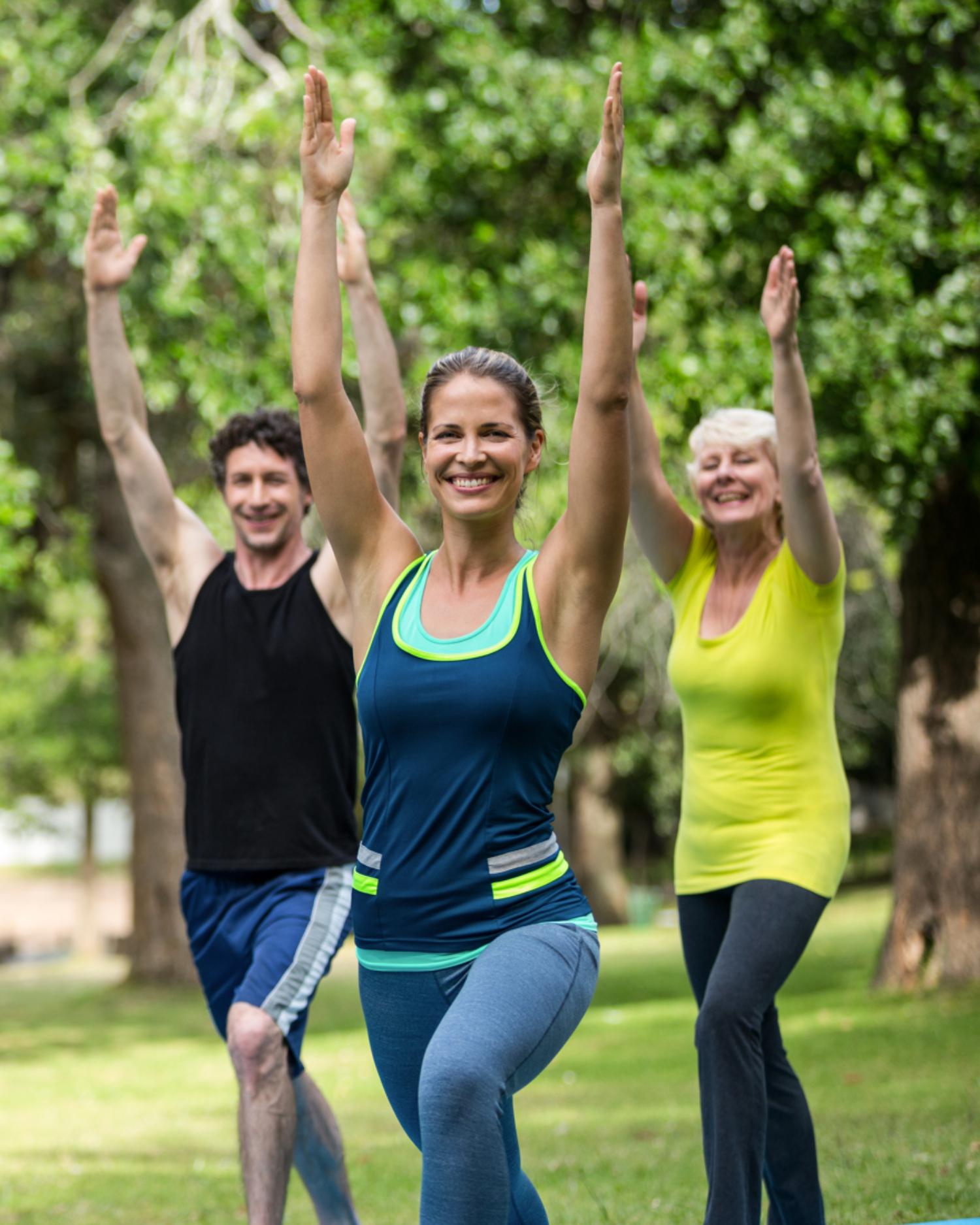 A group doing yoga outdoors on the great lawn at Canyon Ranch Lenox