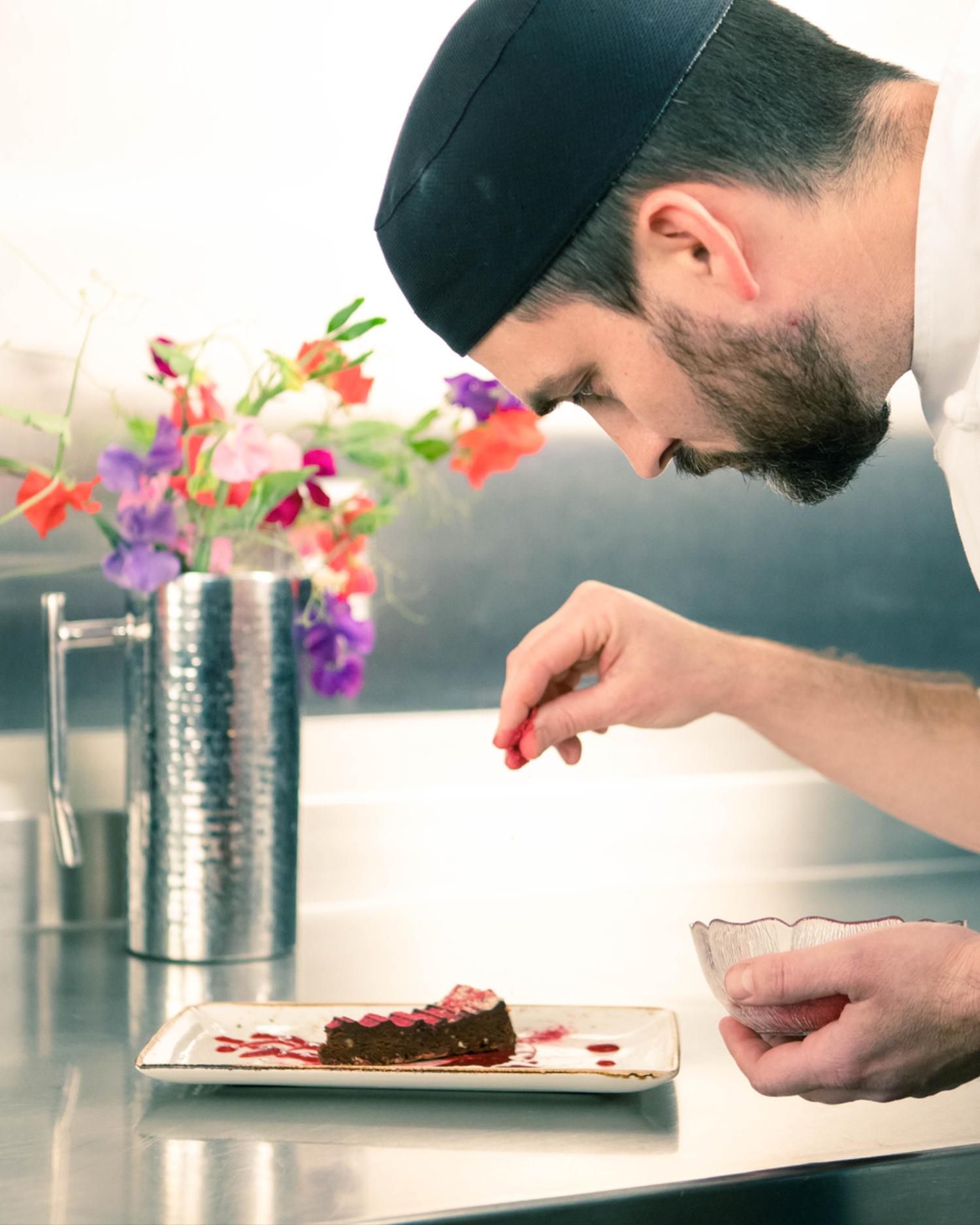 A chef at Canyon Ranch Tucson putting the finishing touches on a dessert plate. 