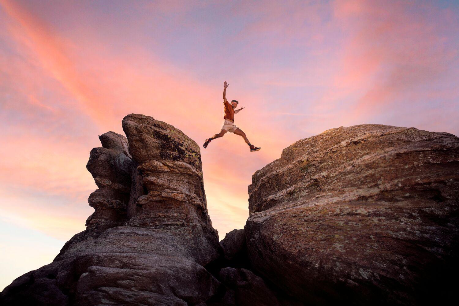 A man leaping on boulders in the desert