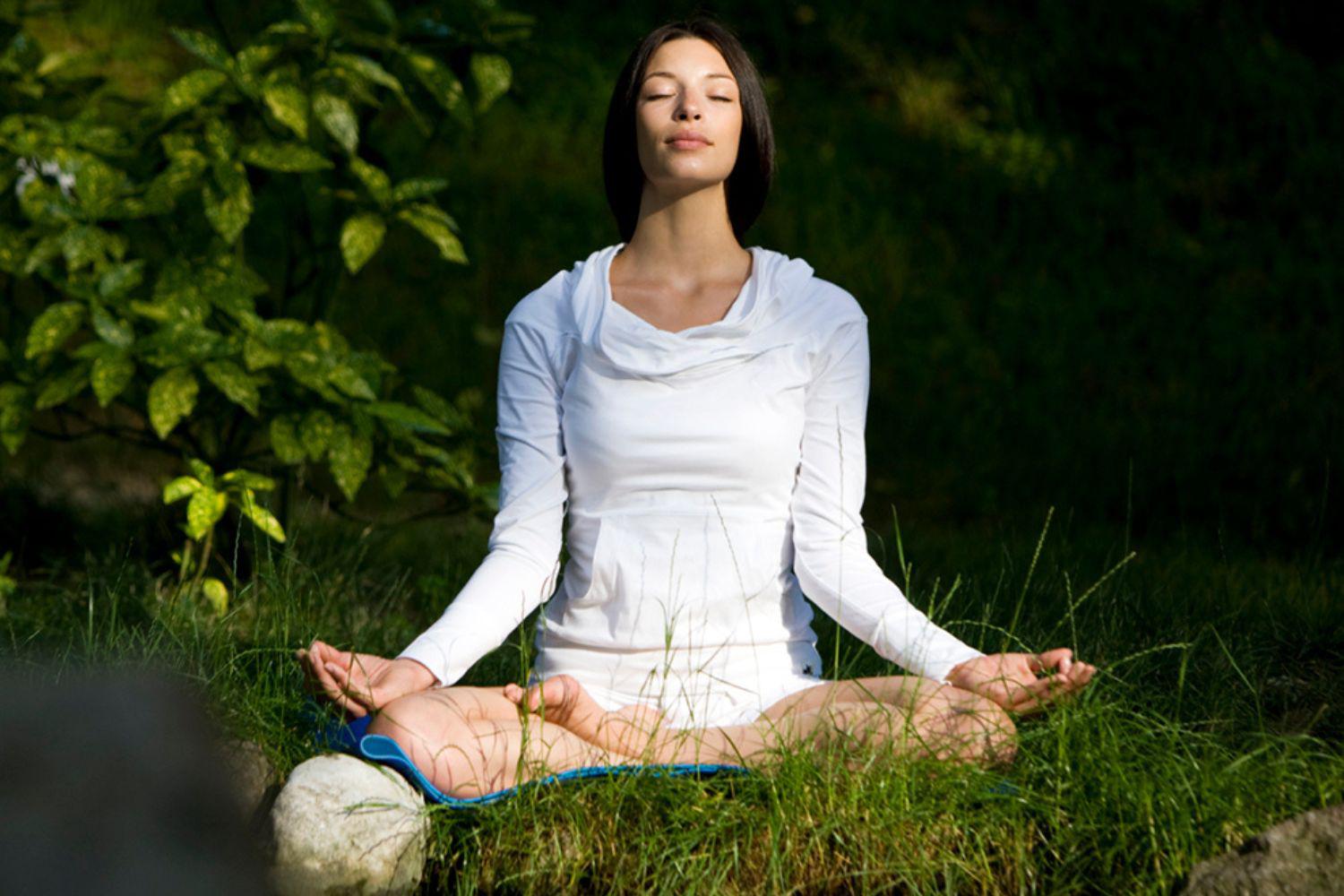 a woman meditating at a retreat in the woods at Canyon Ranch Tucson Health + Spa Resort 