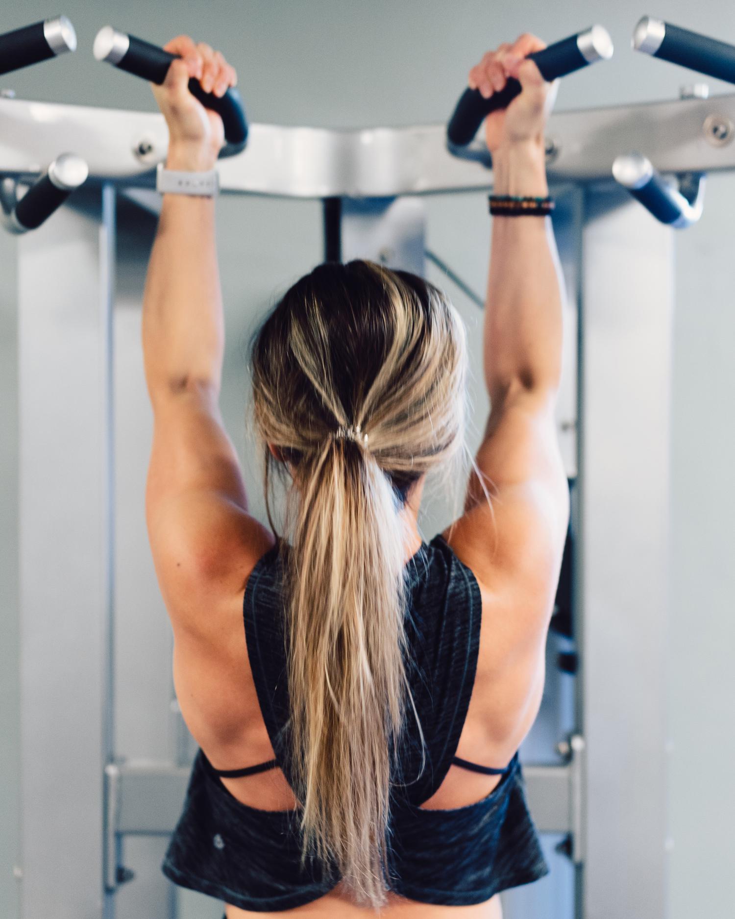Woman doing a body pull-up 