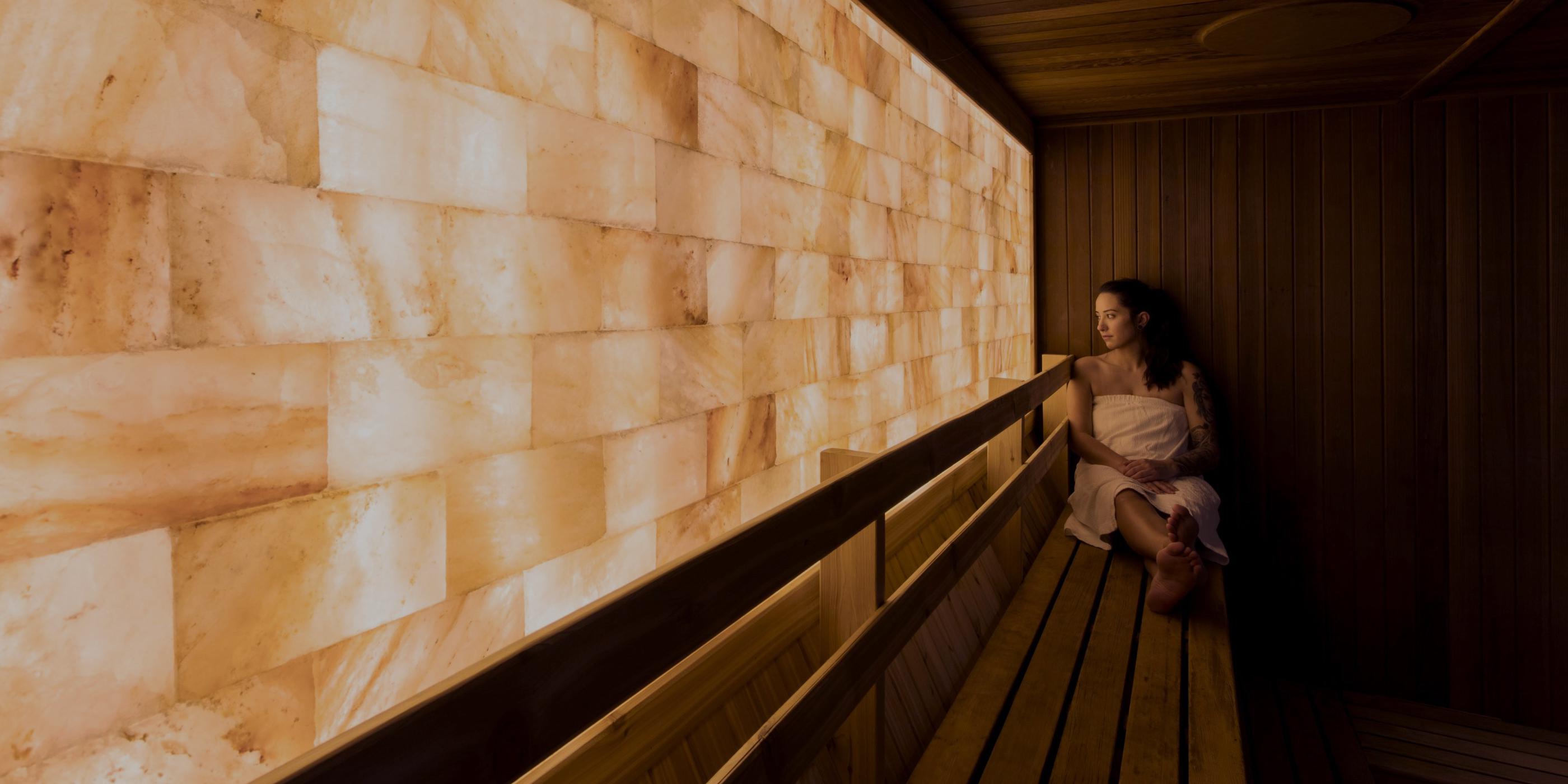 Woman sitting in salt wall sauna