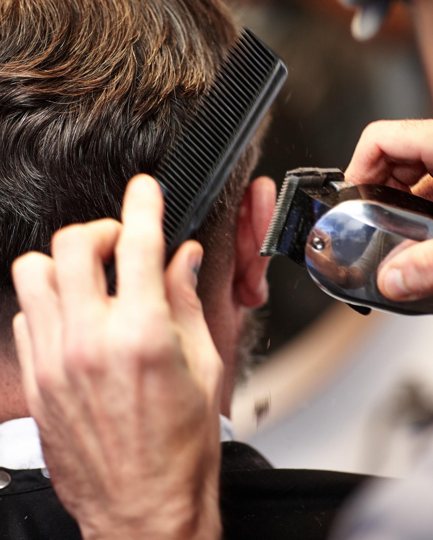 Close-up image of man getting haircut.