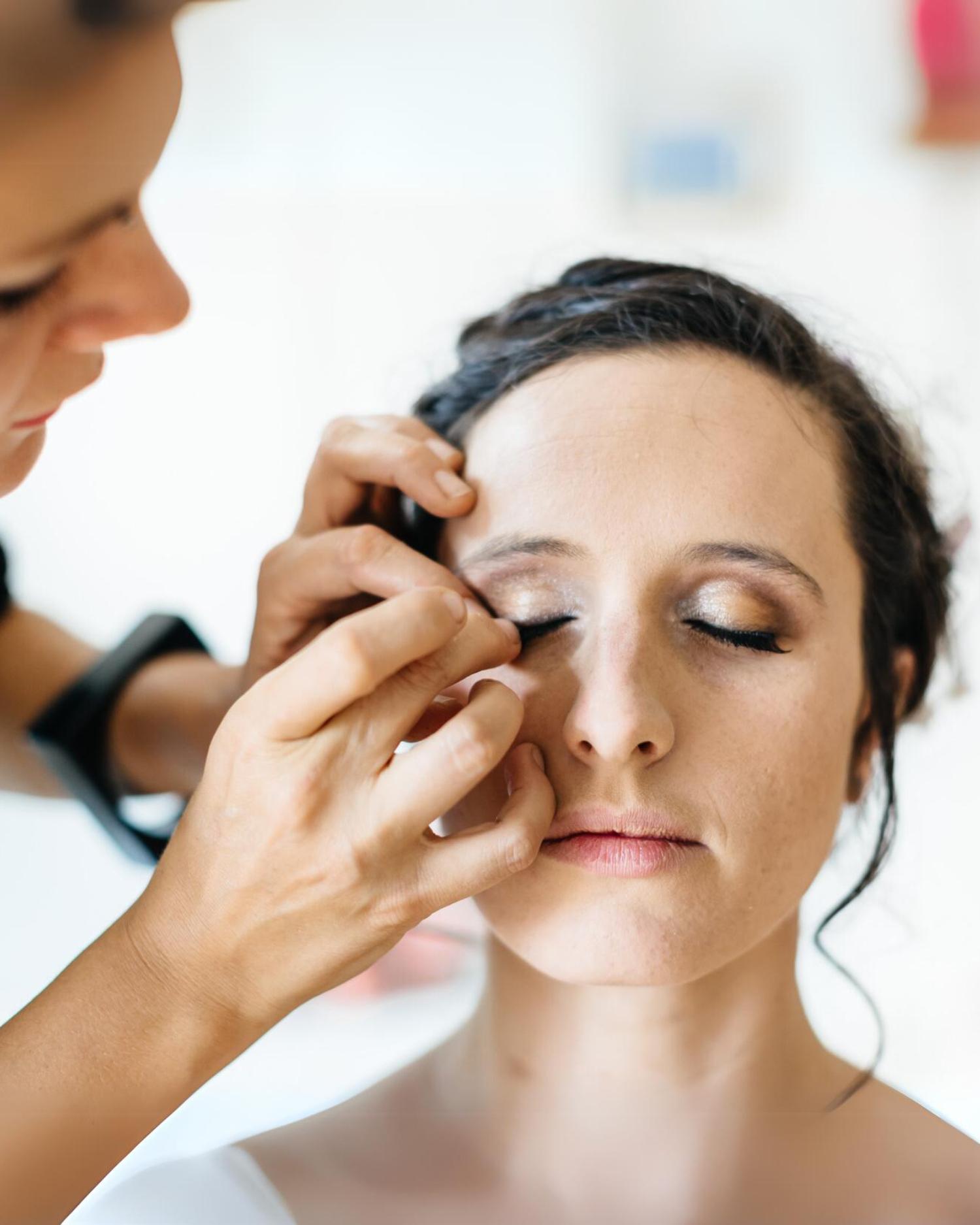 A woman getting her makeup applied