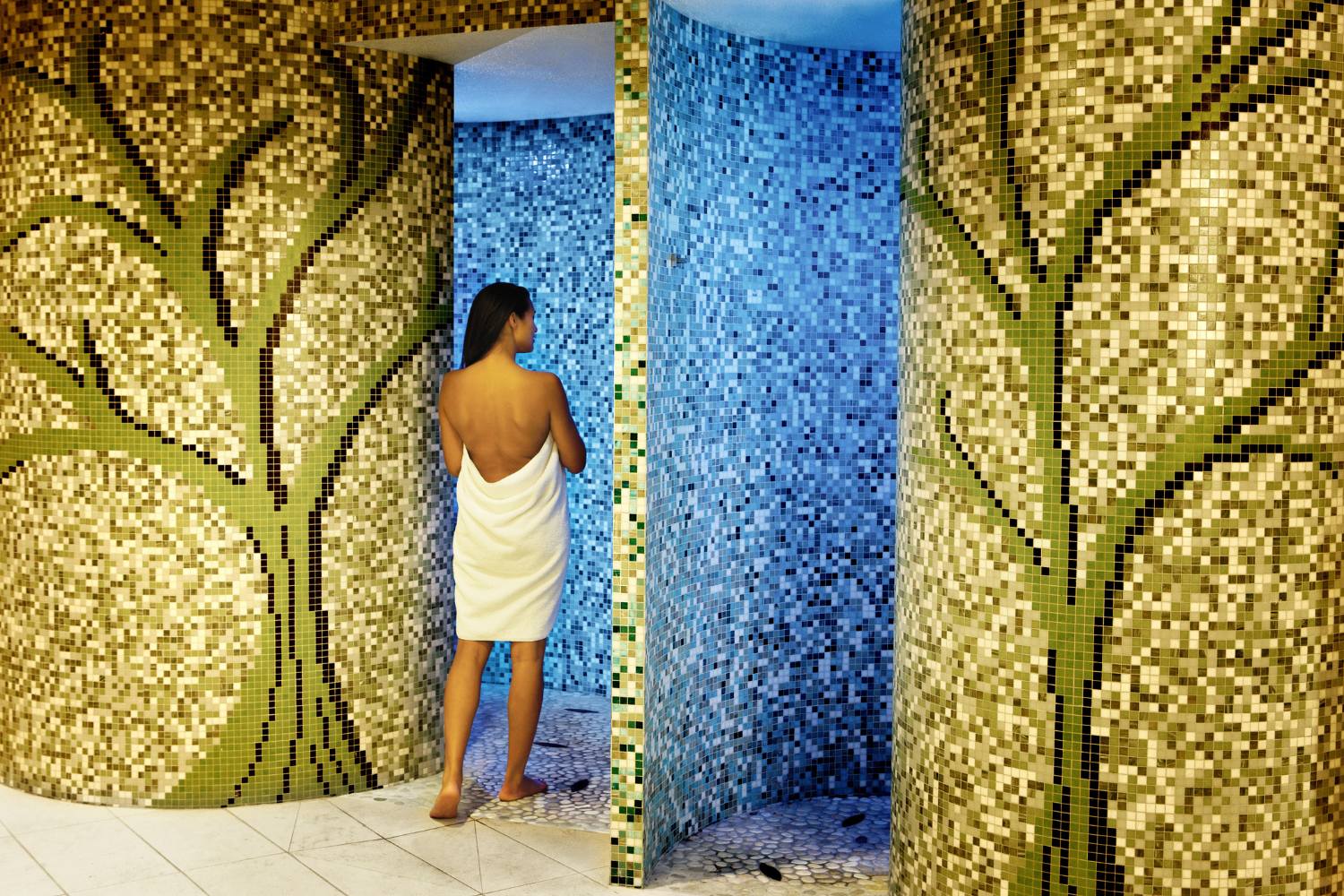 a woman entering the experimental rain room at Canyon Ranch Las Vegas Spa