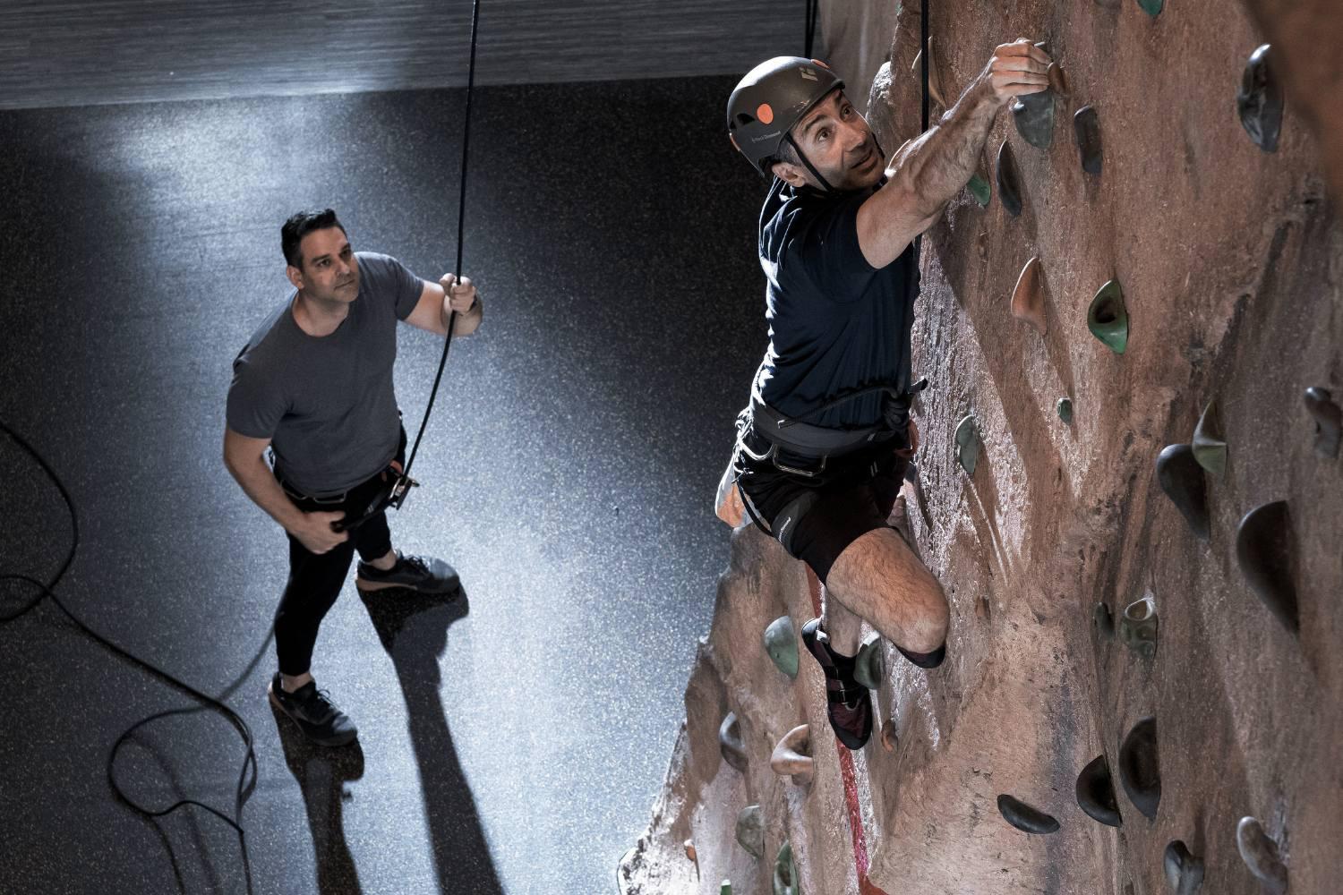 a man climbing the rock wall with an instructor at Canyon Ranch Las Vegas Sap
