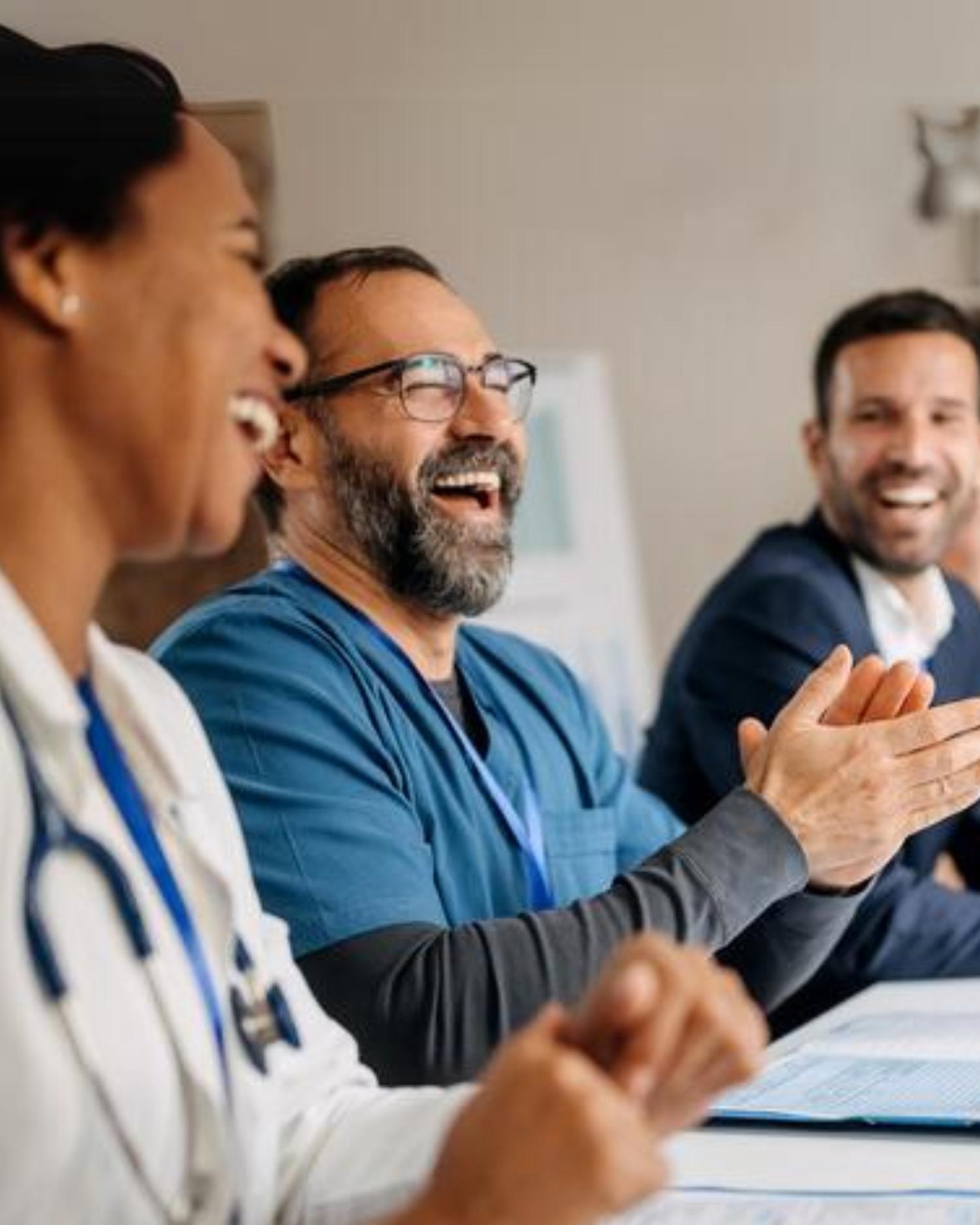 a group of physicians talking and laughing