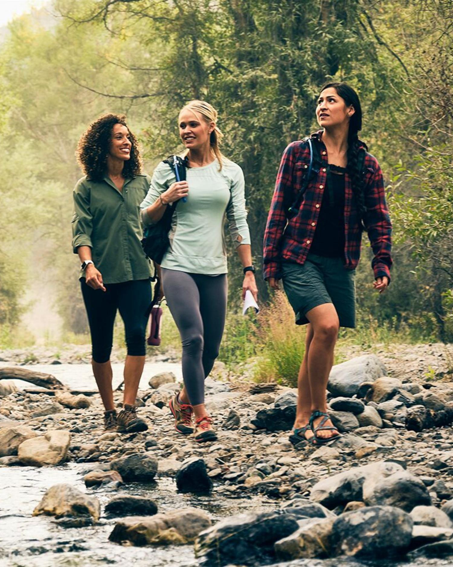 An image of women hiking by a forest stream at Canyon Ranch Fort Worth Health Resort
