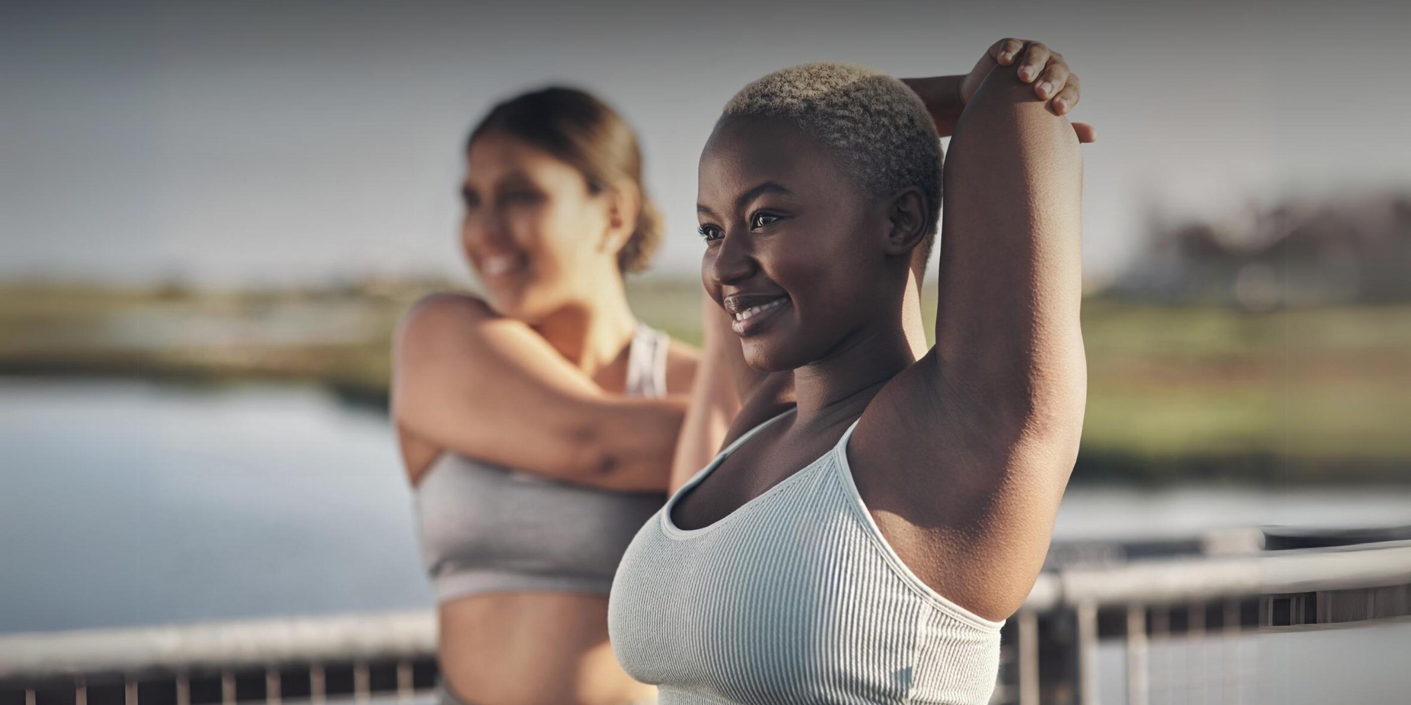 two women stretching at an adult fat camp