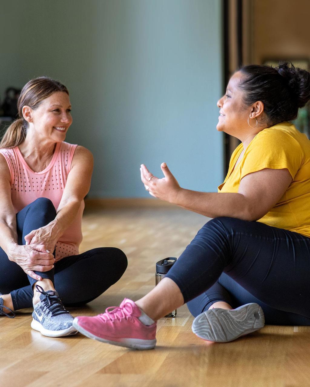 two women chatting after a work out