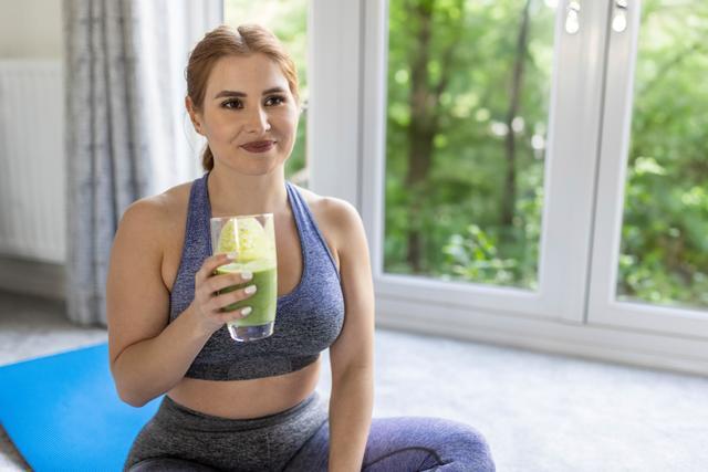 a woman drinking a weight loss smoothie