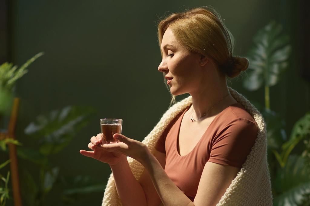a woman drinking herbal tea