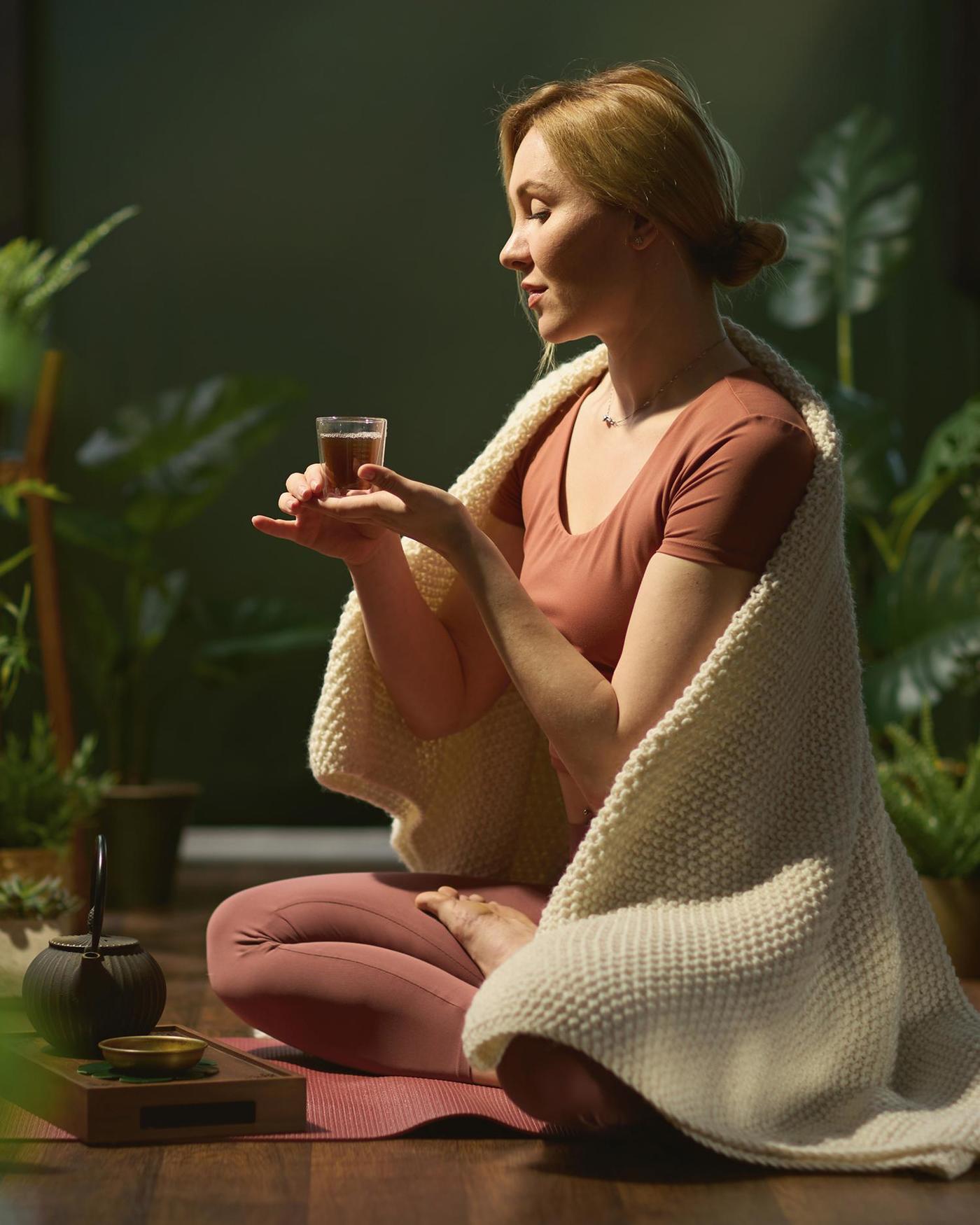 a woman drinking herbal tea