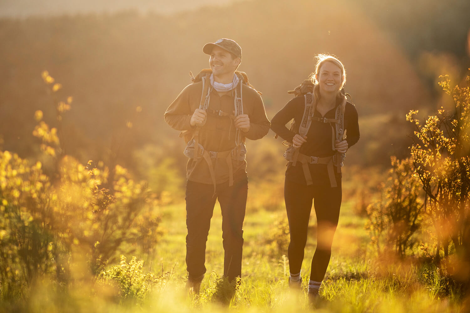 A couple walking in a meadow