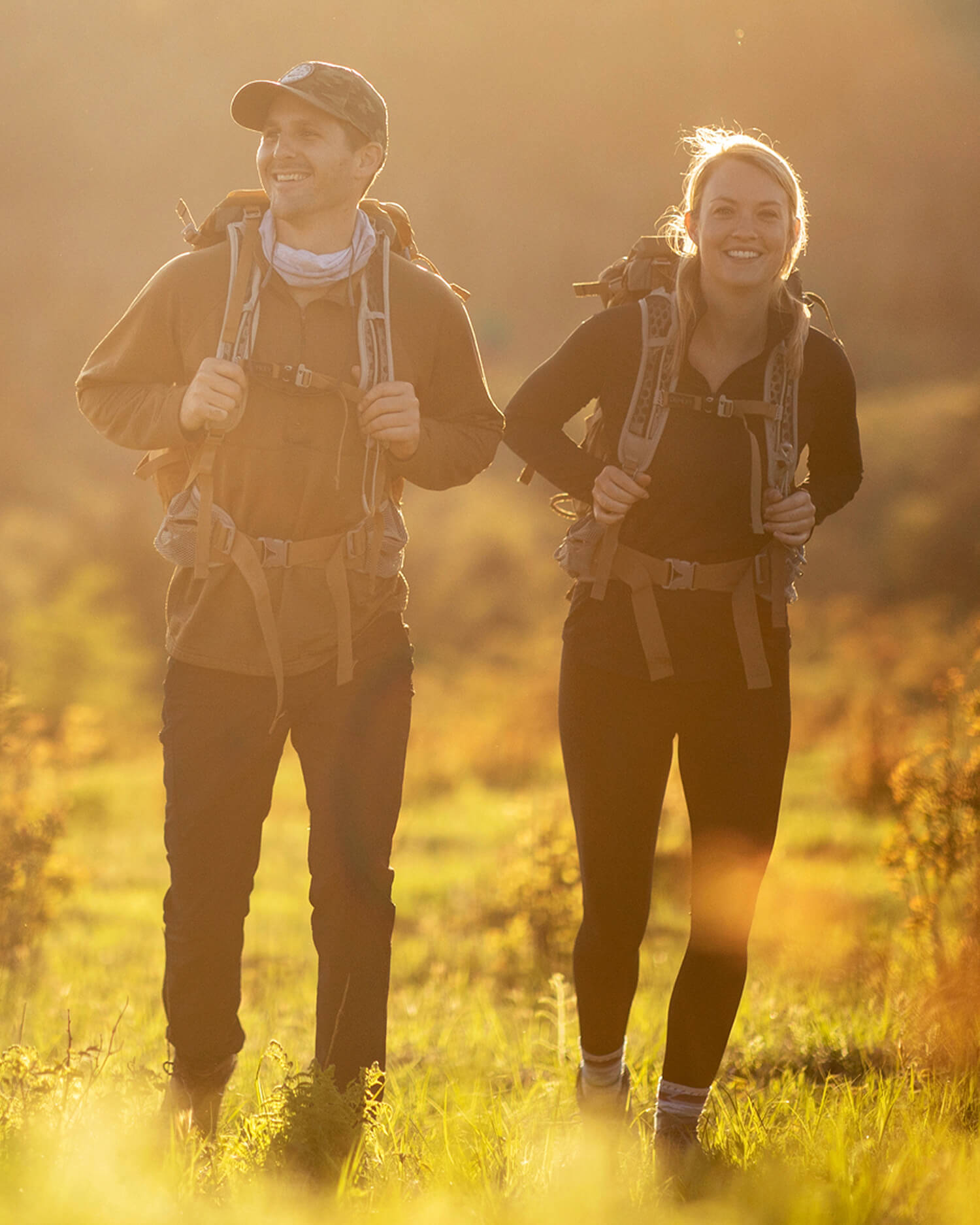A couple walking in a meadow