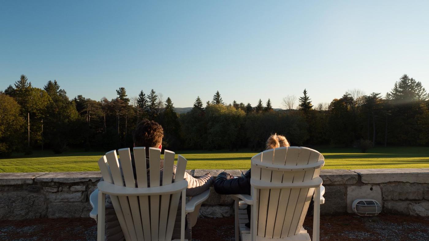 Couple sitting chairs looking at Great Lawn