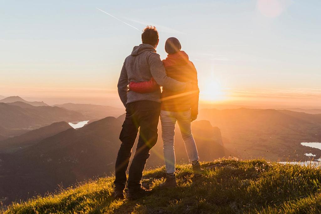 couple looking out over mountains at sunset