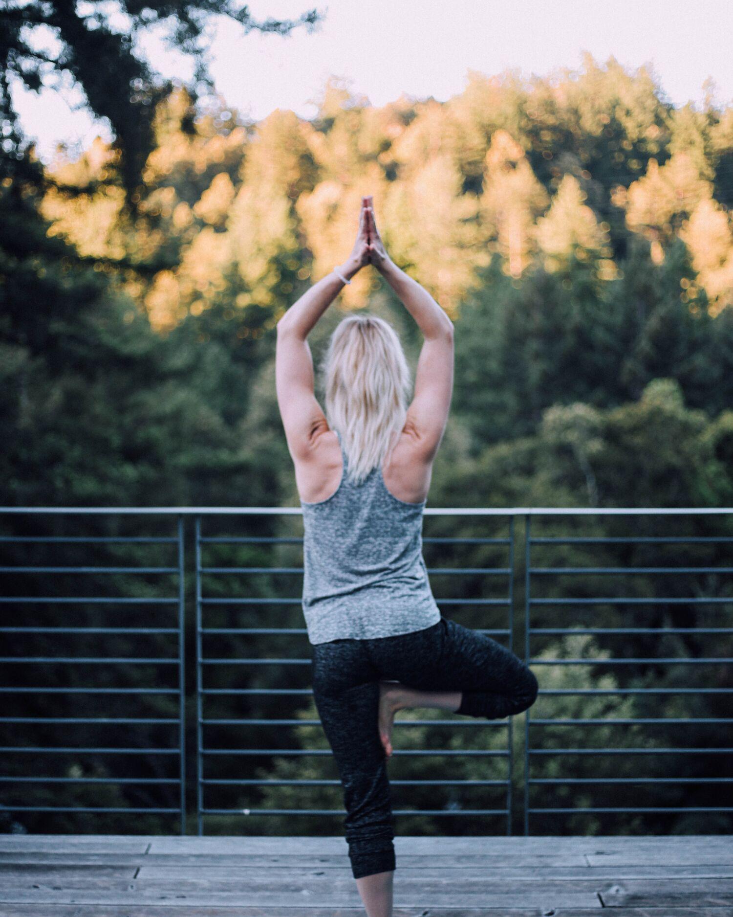 a woman doing yoga on the deck at Canyon Ranch Woodside