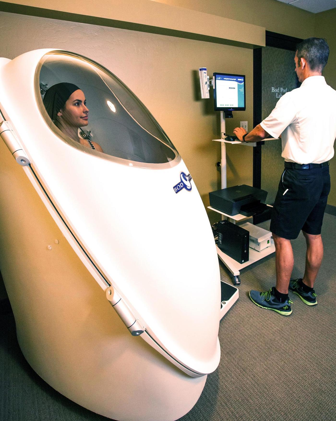 a woman in a bodpod getting a body composition screening at Canyon Ranch Tucson health spa resort