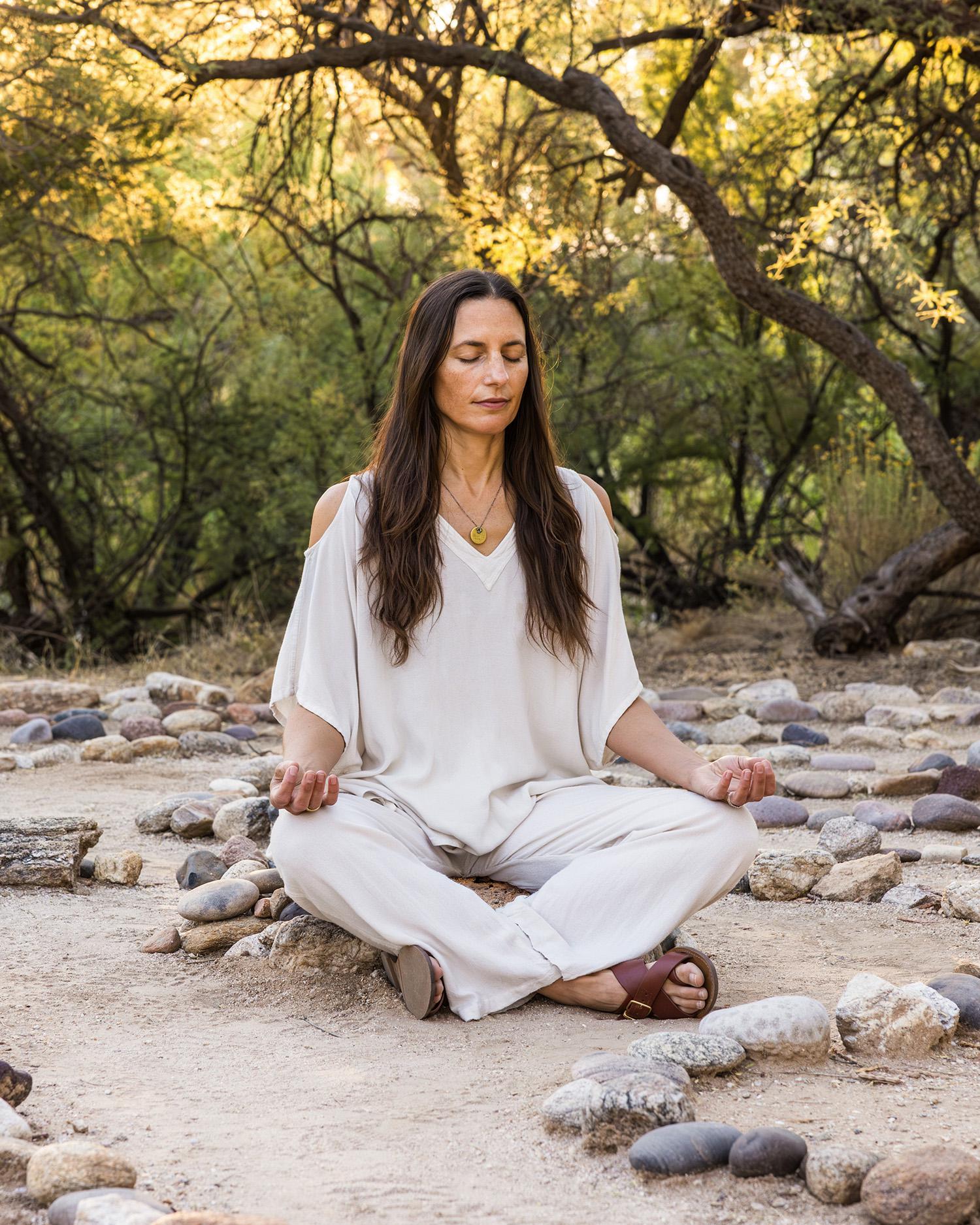 A woman meditating outdoors