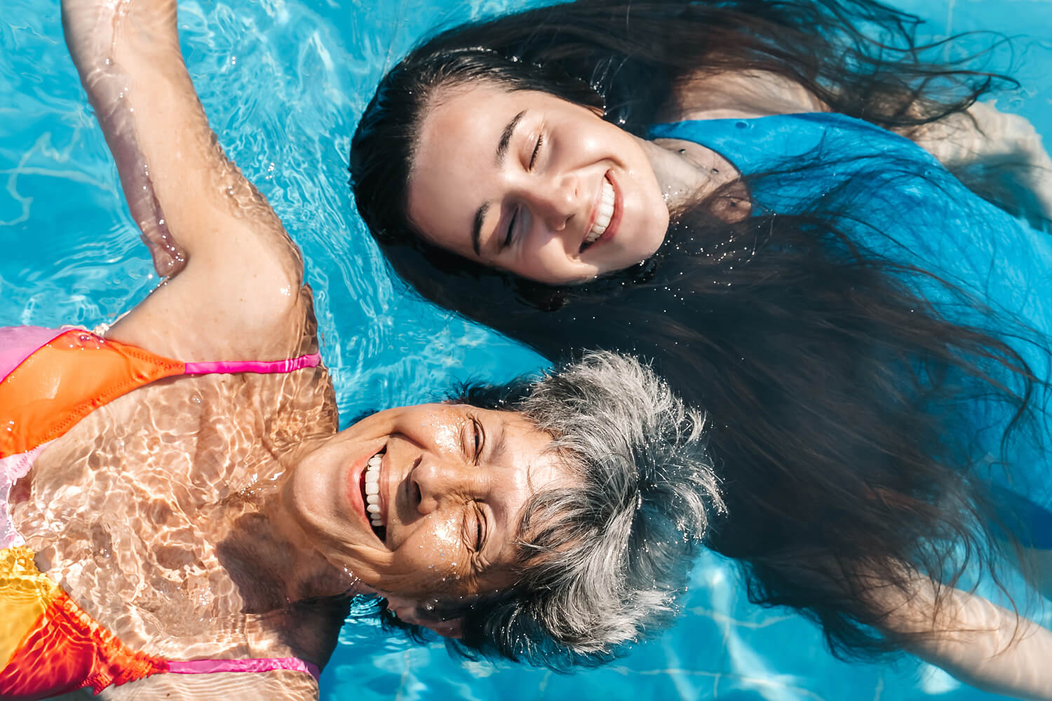 A woman and her daughter in the pool