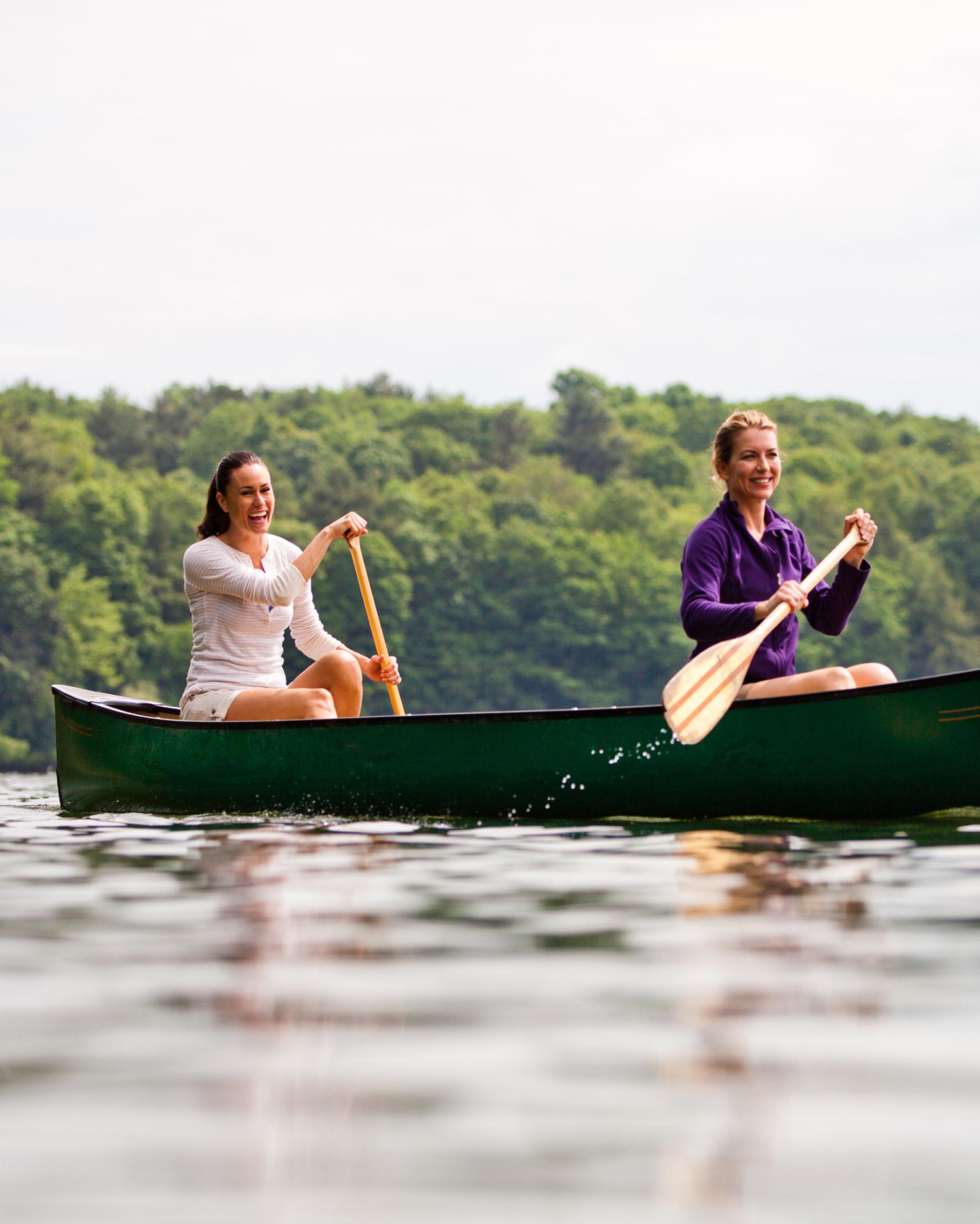 A woman paddle boarding on the lake