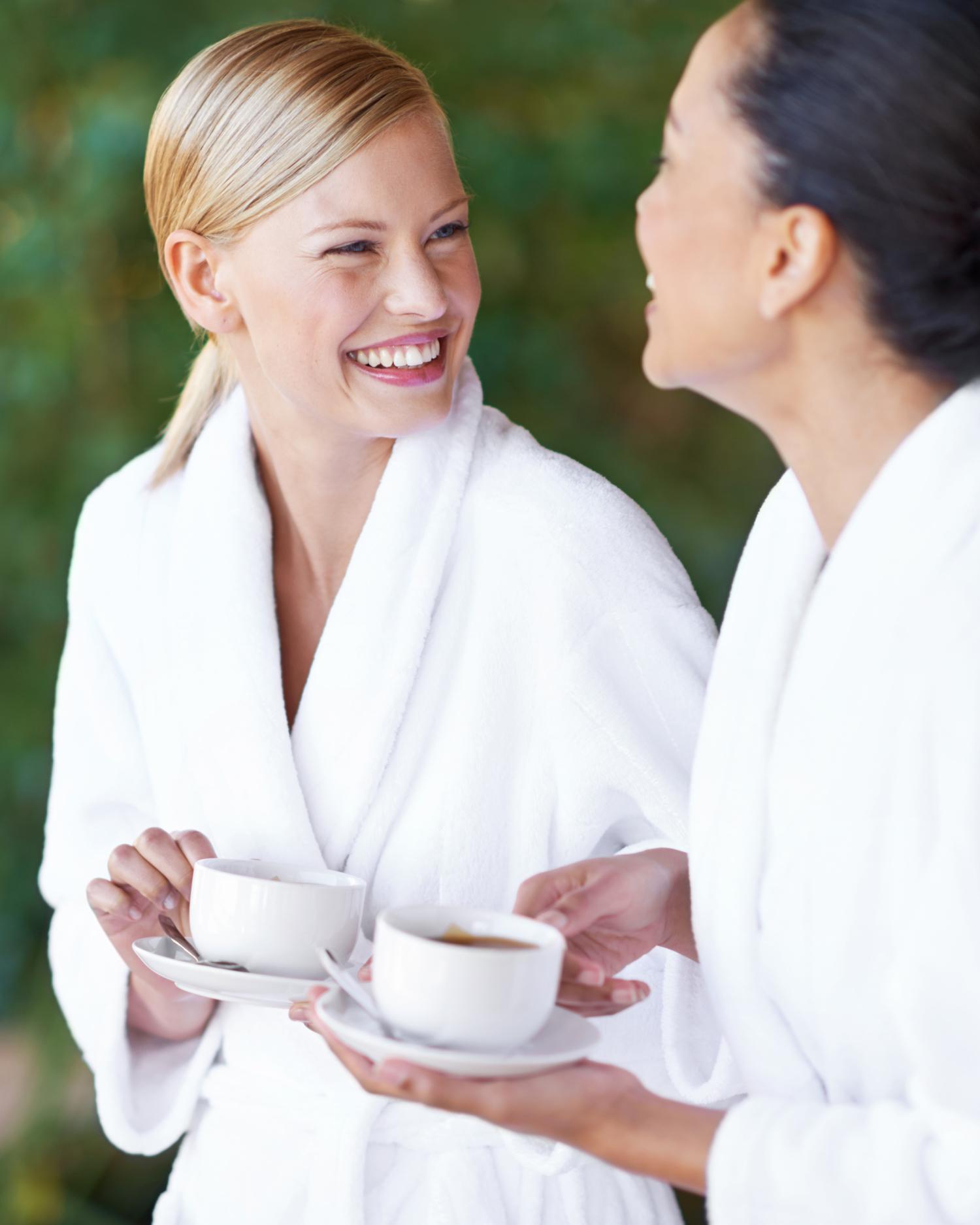 Two women in white spa robes