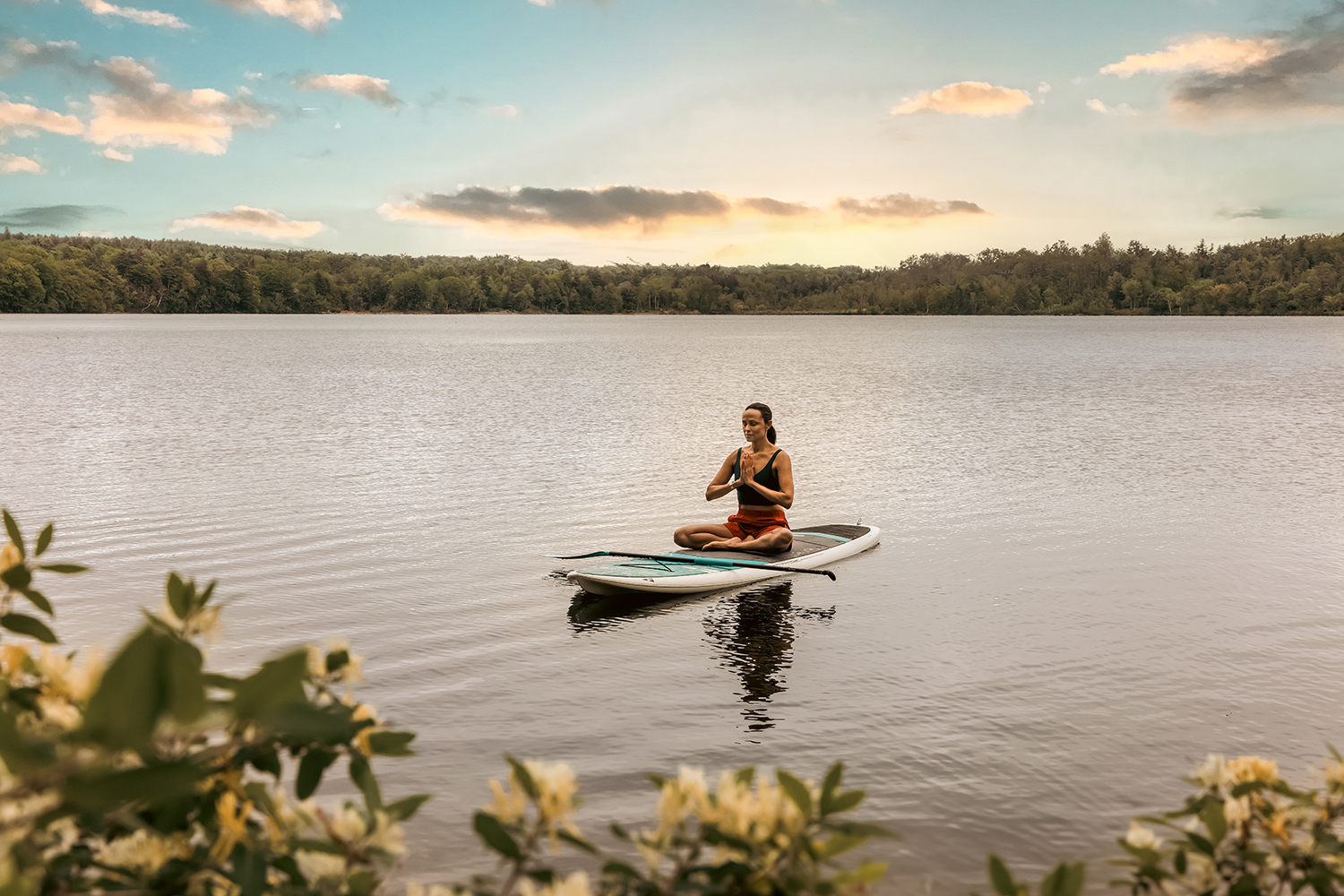 Woman Meditating on Paddle Board