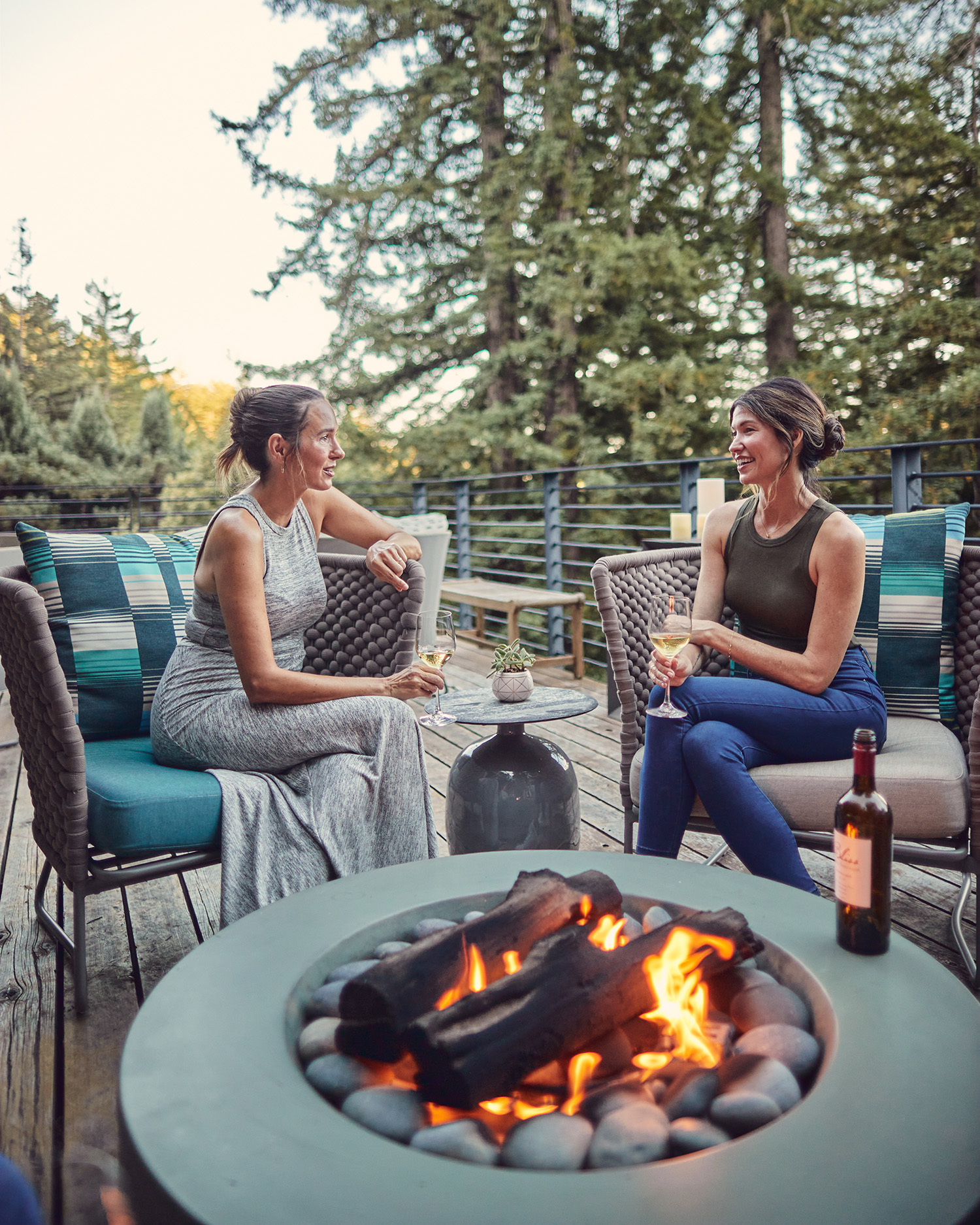 Two women drinking wine at the hearth 