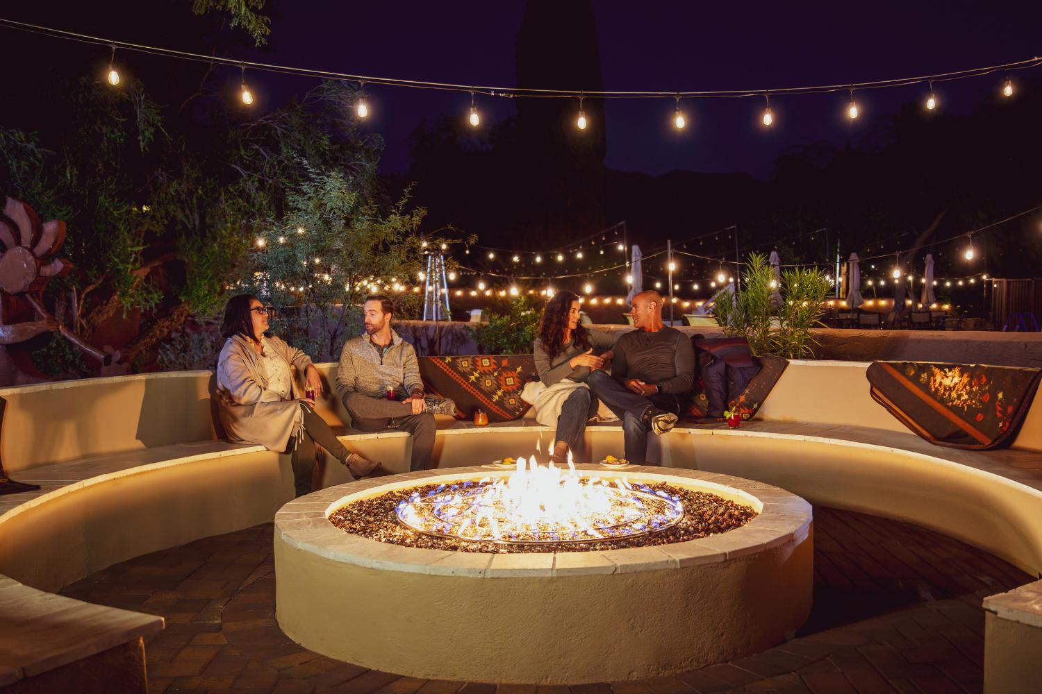People Gathered Around a Propane Firepit 